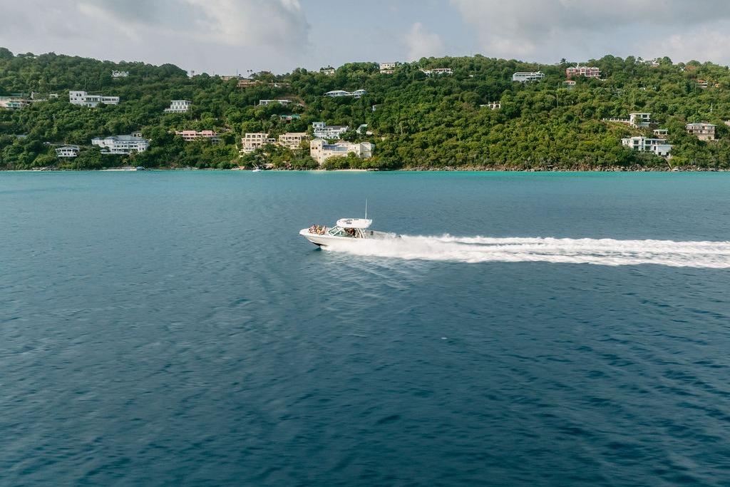 Ares Custom Marine 2012 boat cruising near lush coastline, clear blue waters.