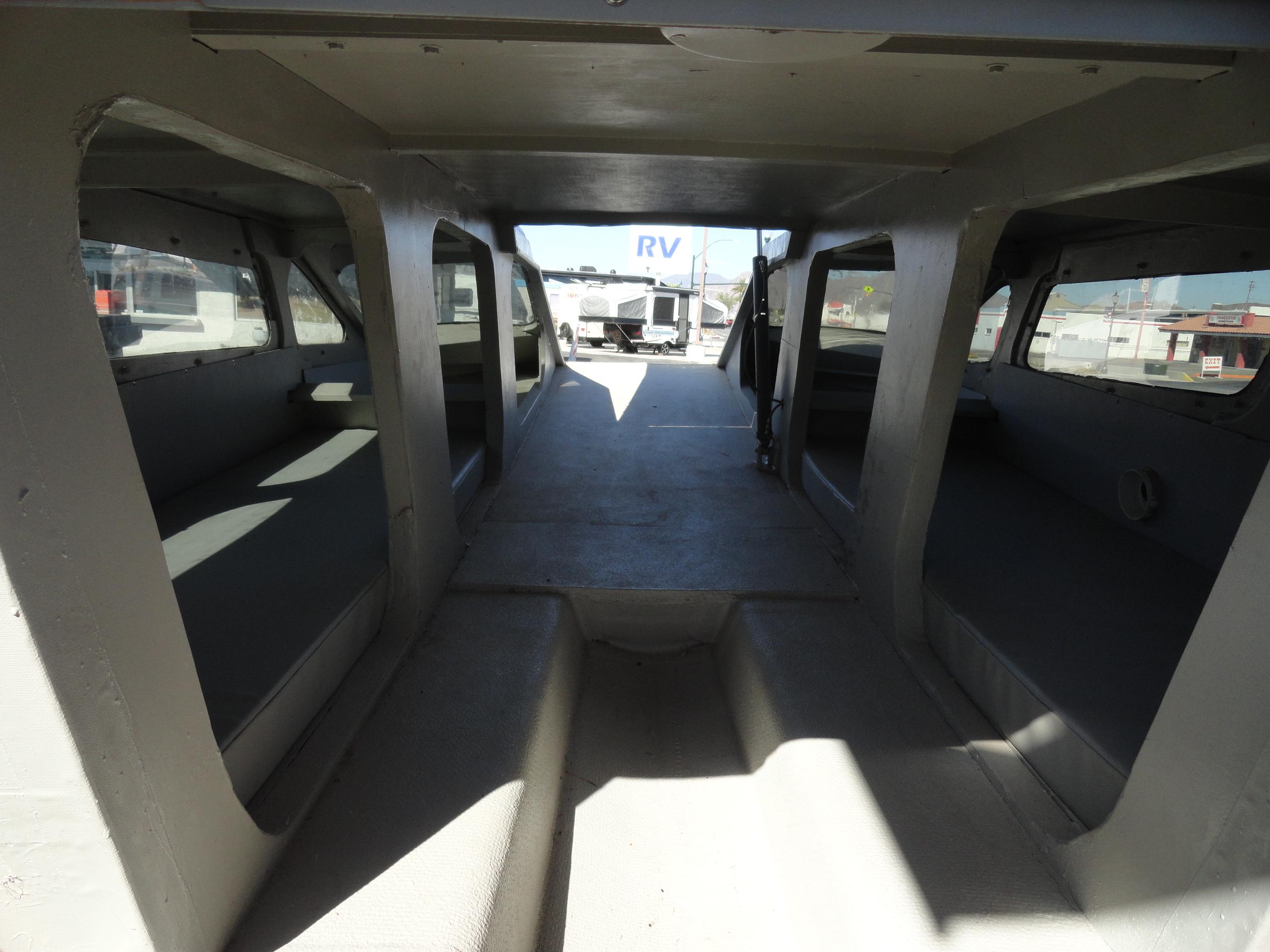 Interior of 1996 Hallett Party Cruiser Gull Wing 300 boat with seating and windows.