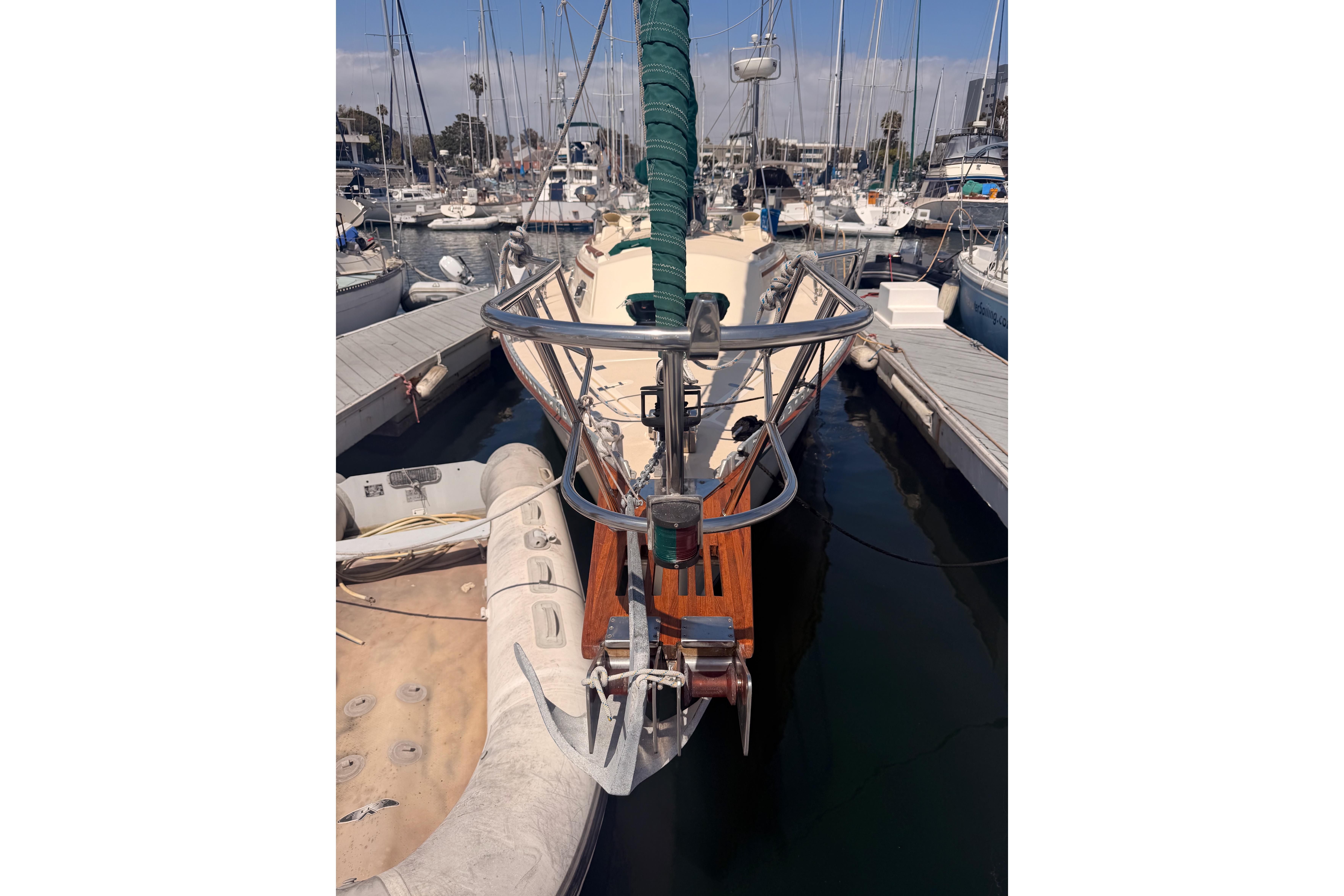 1991 Caliber 33 sailboat docked at marina with inflatable dinghy.