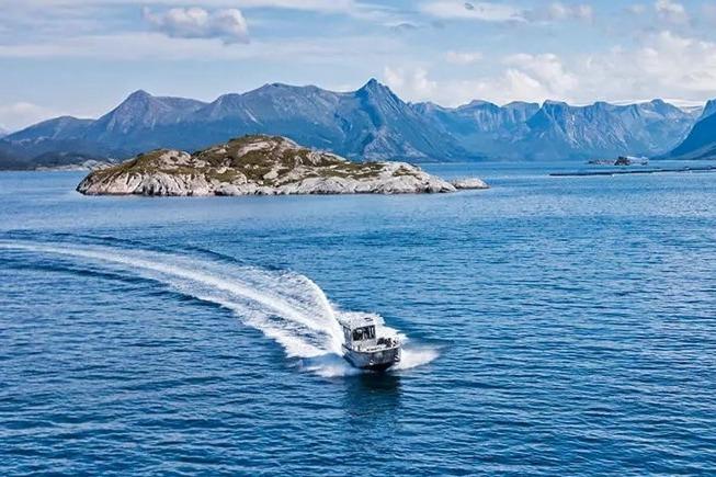 Boat cruising near island with mountains in background, ALUTEH LC 853, 2018 model.