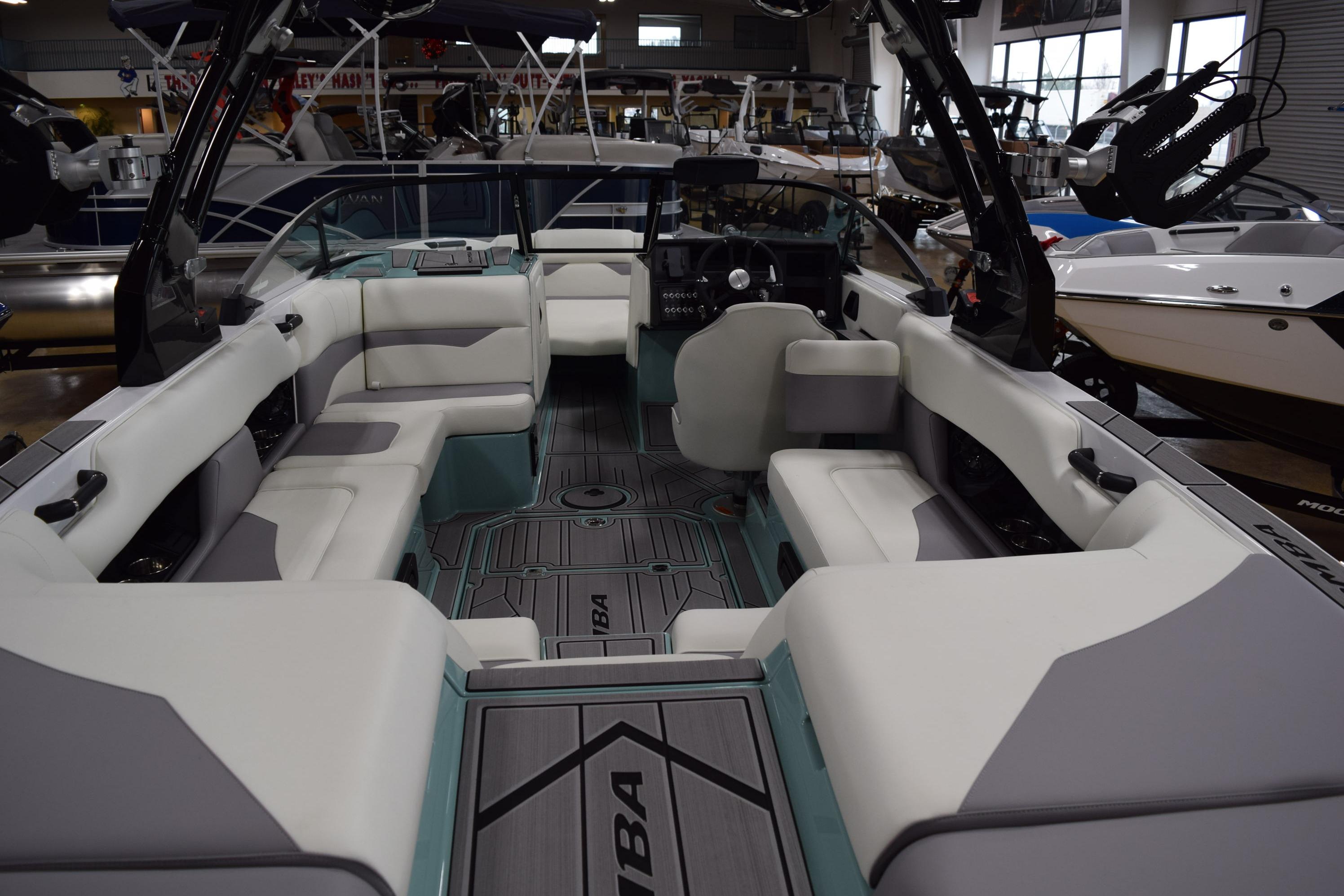 2025 Moomba Mojo boat interior with spacious seating and modern design in a showroom.