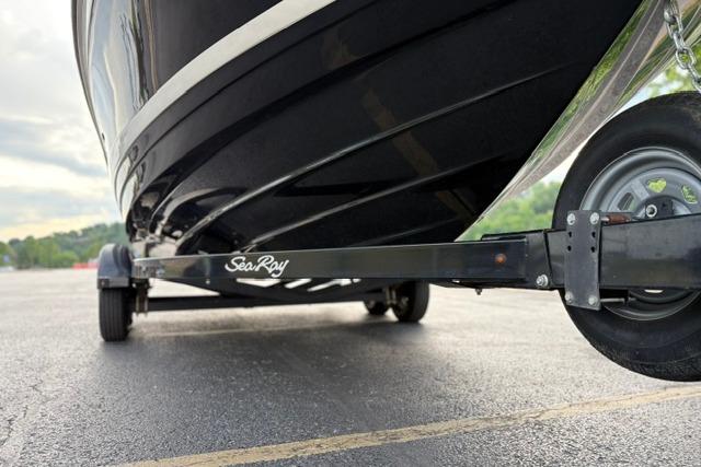 2017 Searay SPX210 boat on trailer, close-up view of hull and wheel.