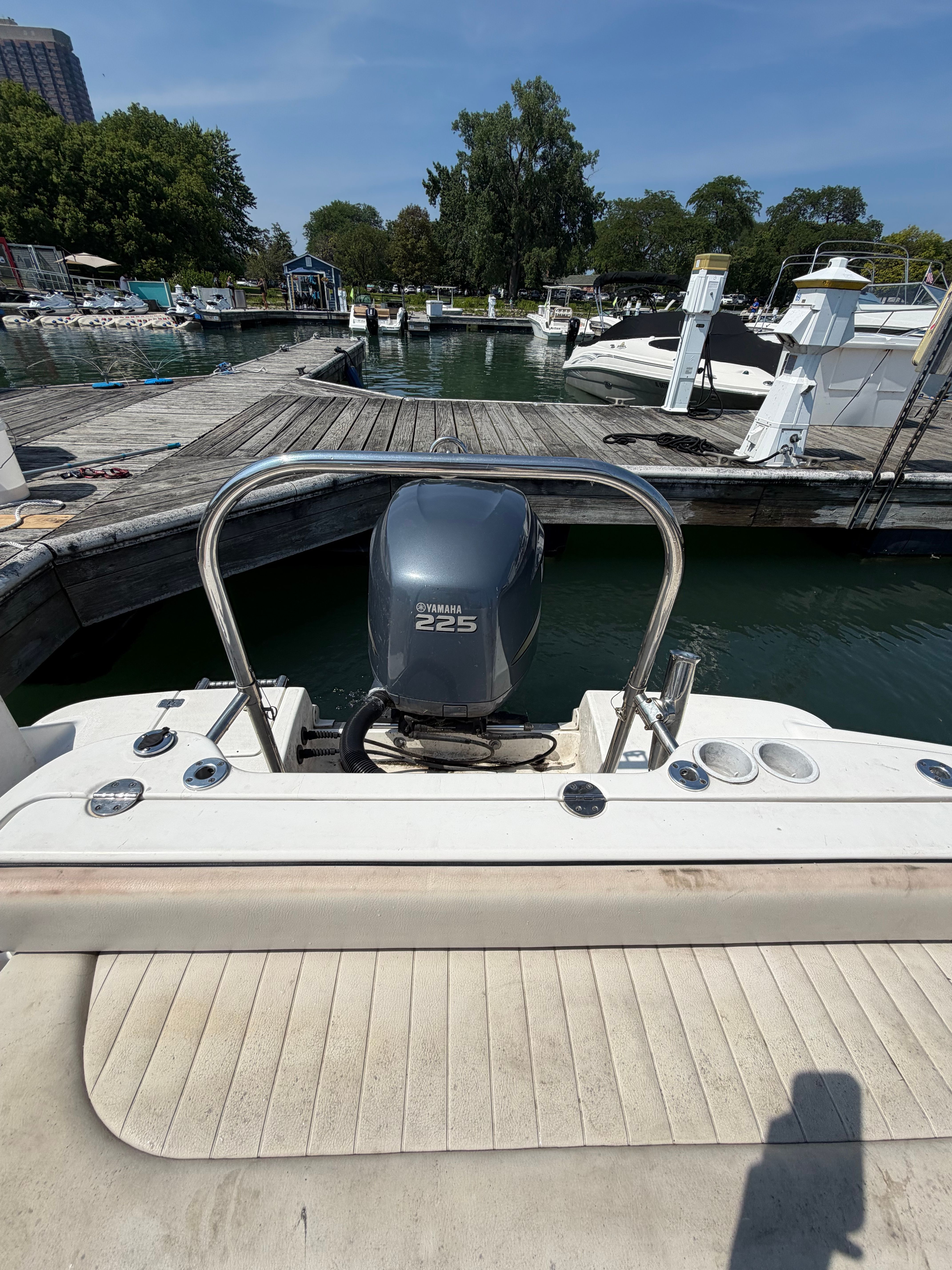 A 2005 Robalo R227 Dual Console boat docked in a marina, featuring a Yamaha 225 outboard motor.