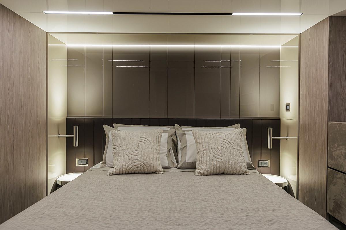 Luxurious bedroom interior of 2025 Cranchi 67 Corsa yacht, featuring modern design and ambient lighting.