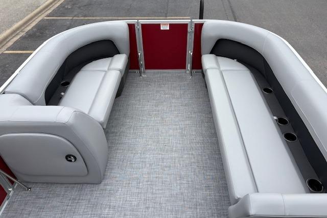 2026 Sun Tracker Party Barge 18 DLX interior with gray seating and red accents.