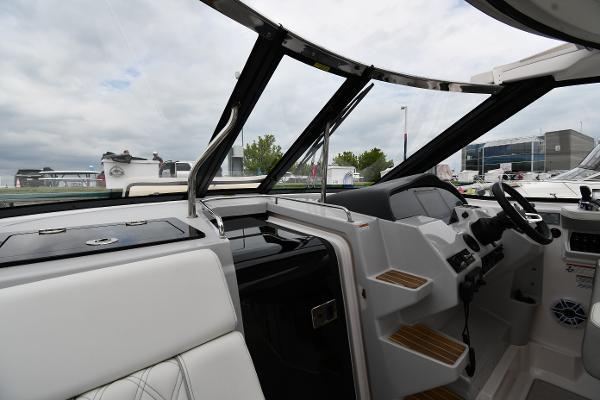 2021 Regal 35 Sport Coupe cockpit with modern controls and seating, under cloudy sky.