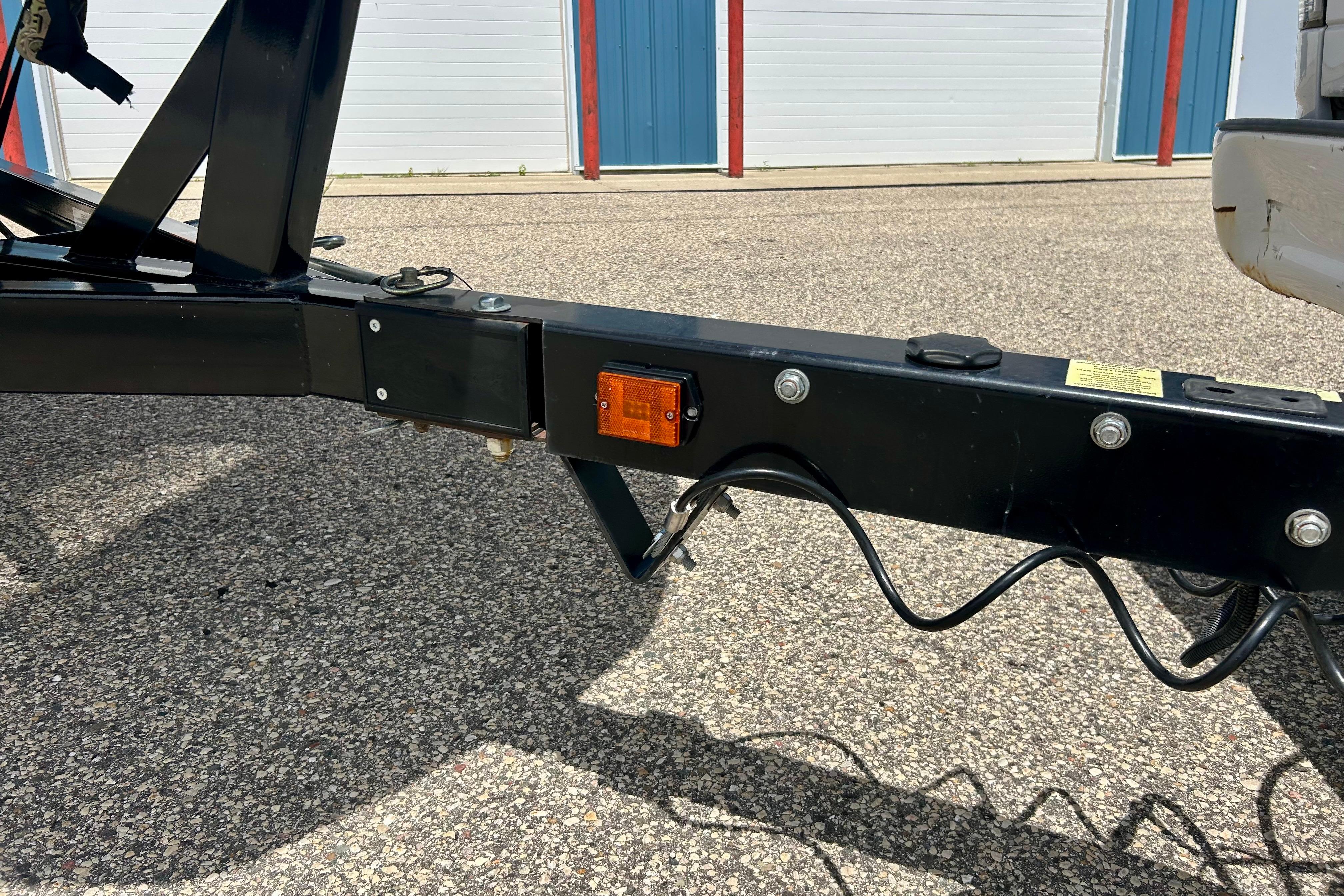 Trailer hitch of a 2021 Scarab 195 ID on asphalt, near storage units.