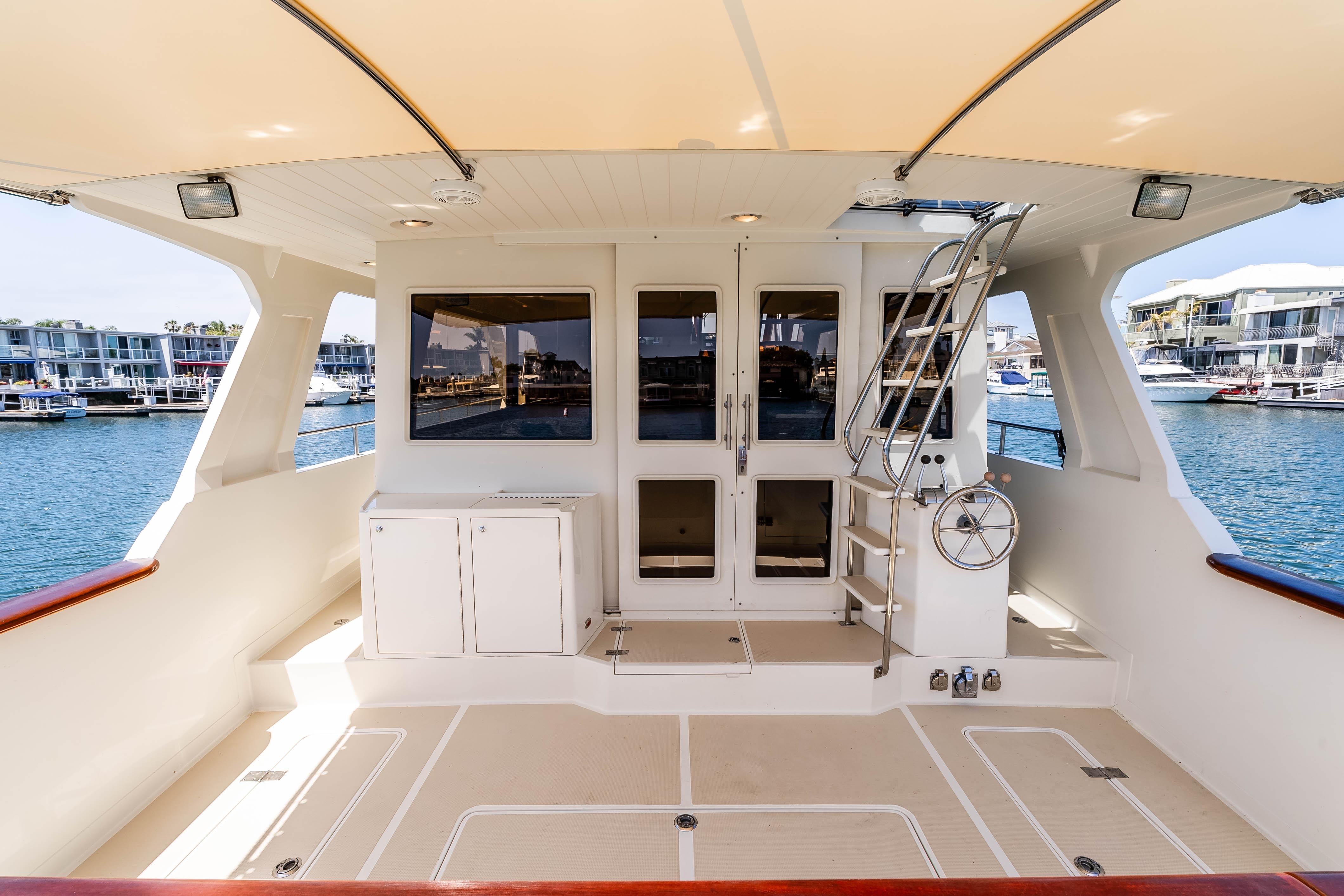 2005 Offshore Yachts 54 Pilothouse aft deck with marina view and elegant design.