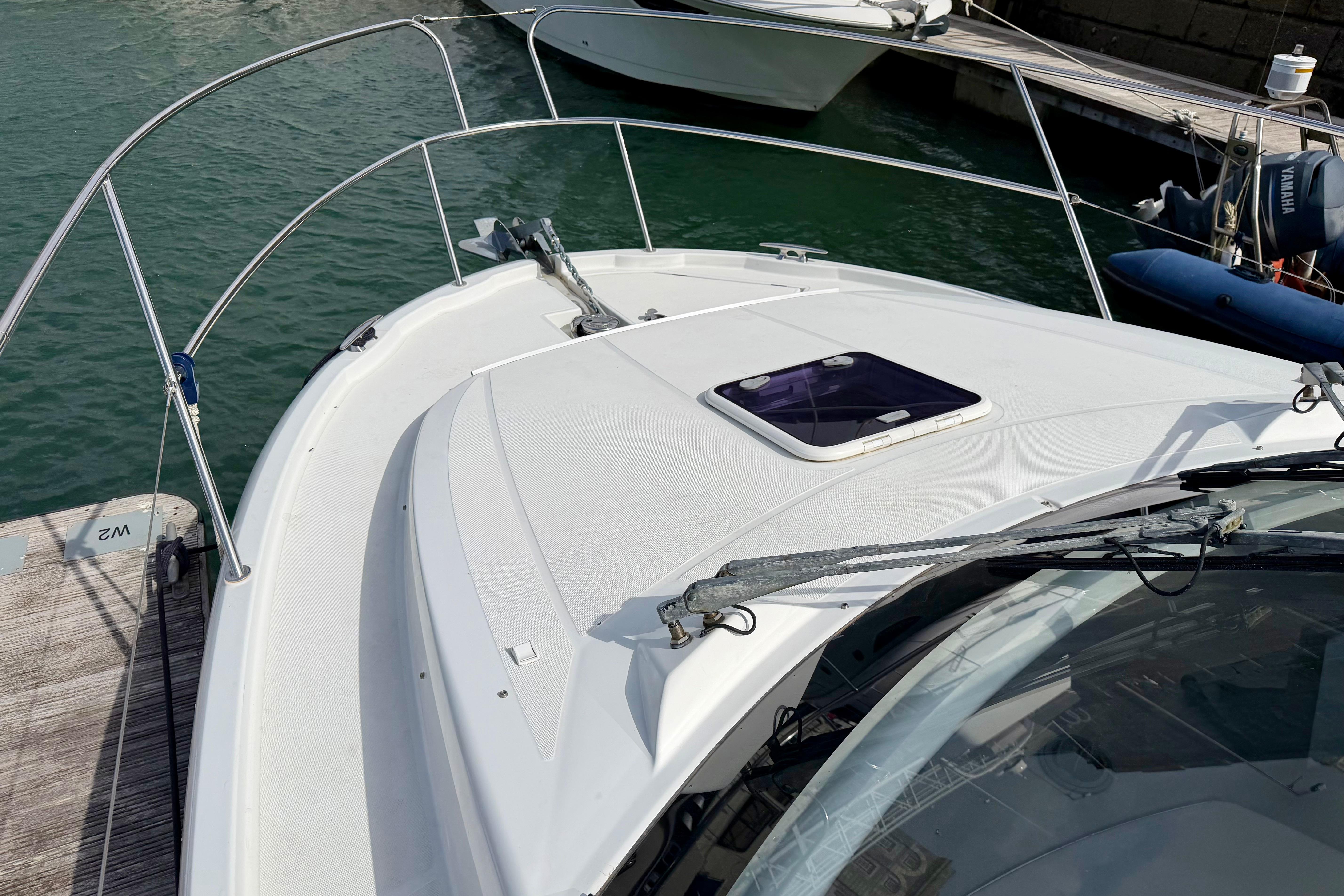 2013 Jeanneau NC 9 boat docked, showcasing sleek deck design and railing.