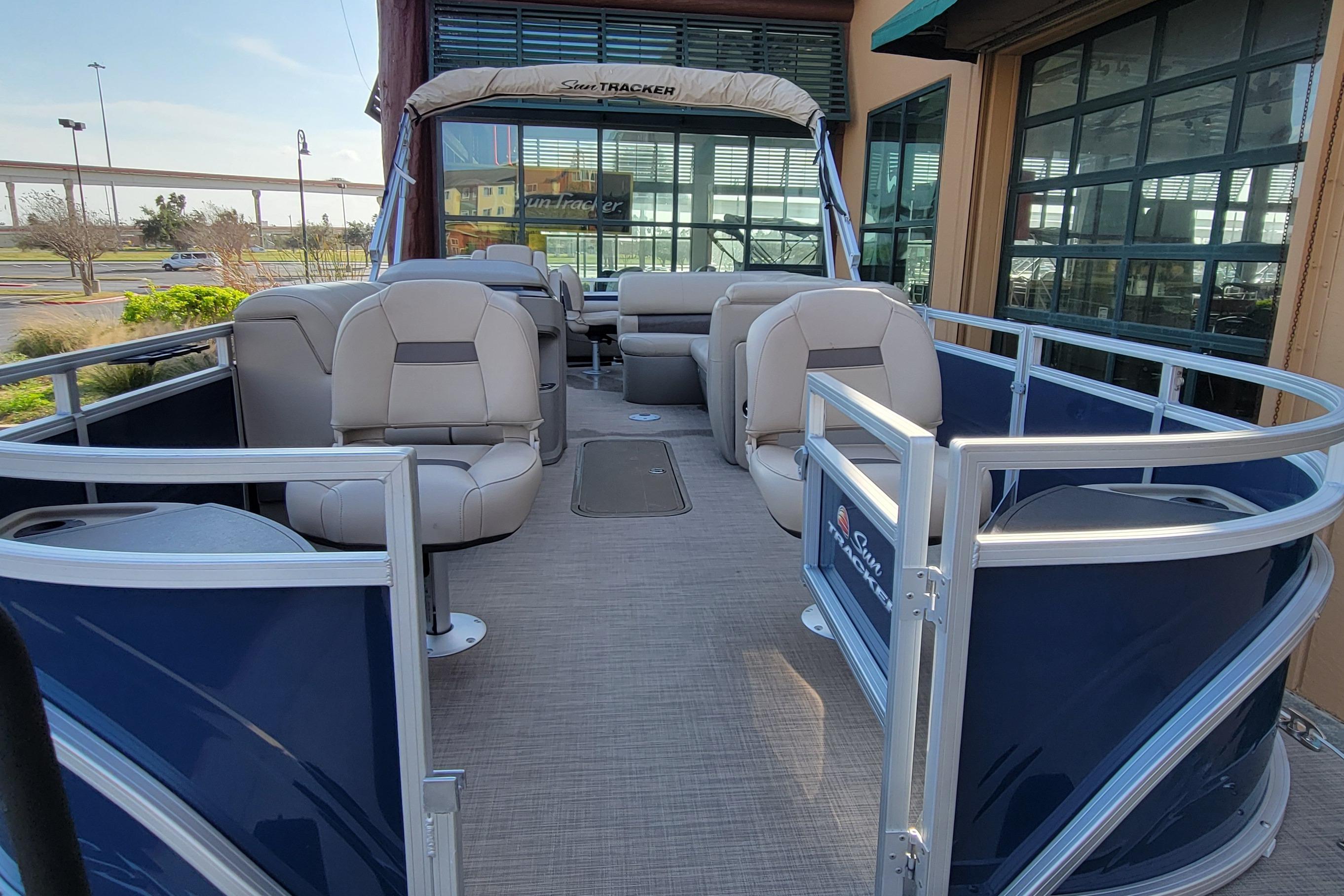 2025 Sun Tracker Fishin' Barge 22 XP3 pontoon boat with spacious seating and modern design.