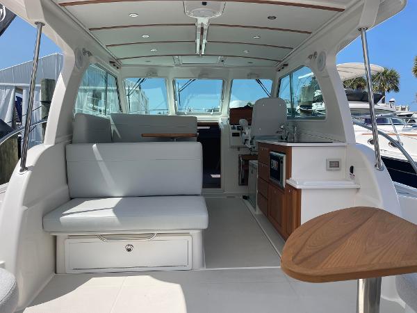 Interior of 2024 Back Cove 34O boat with seating and kitchenette.