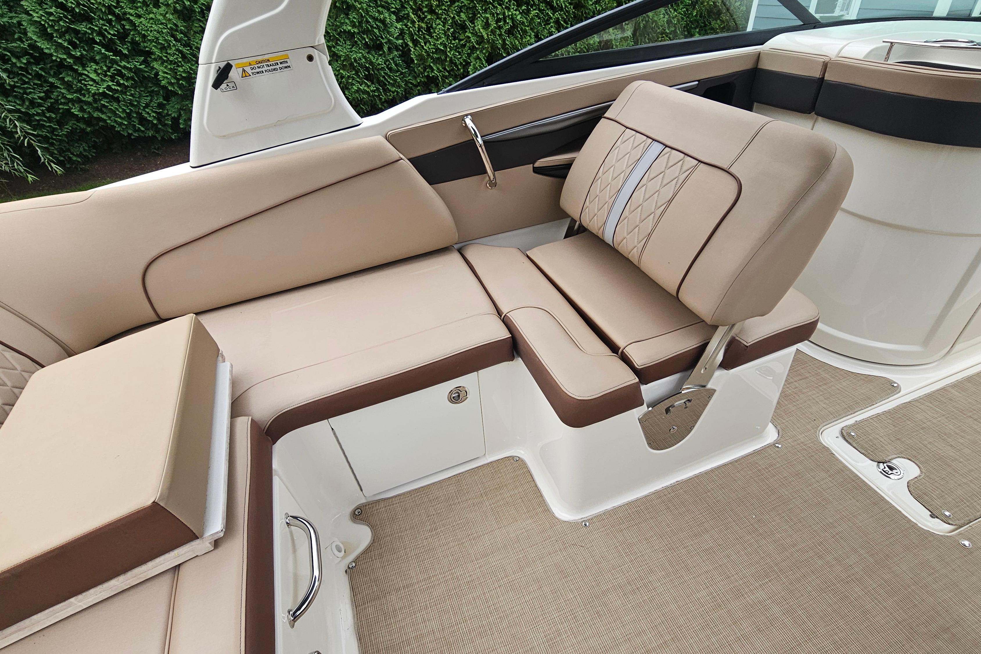 2017 Sea Ray SDX 240 Outboard boat interior with beige and brown seating.