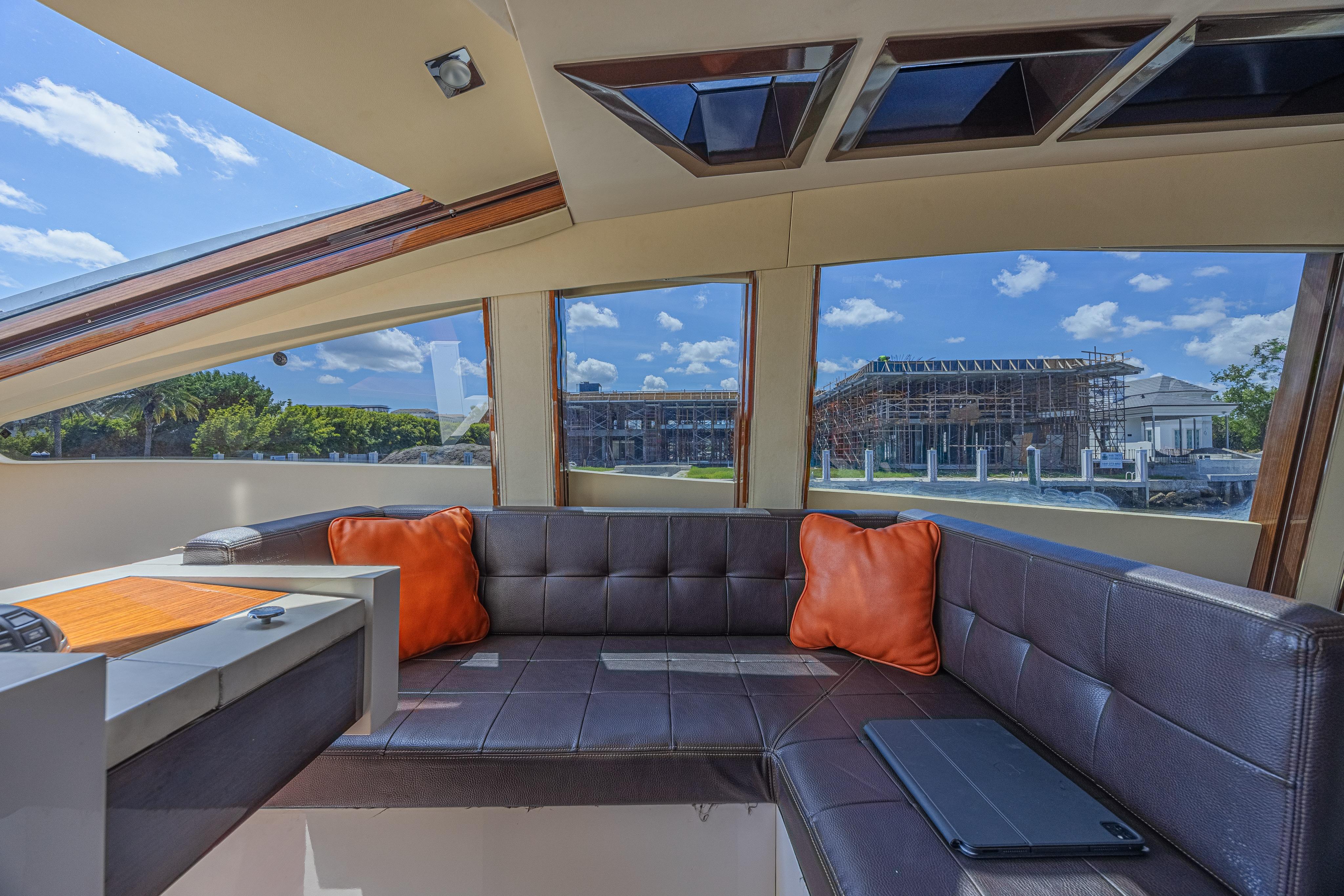 Luxurious interior of 2010 Lazzara LSX 92 yacht with leather seating and scenic windows.