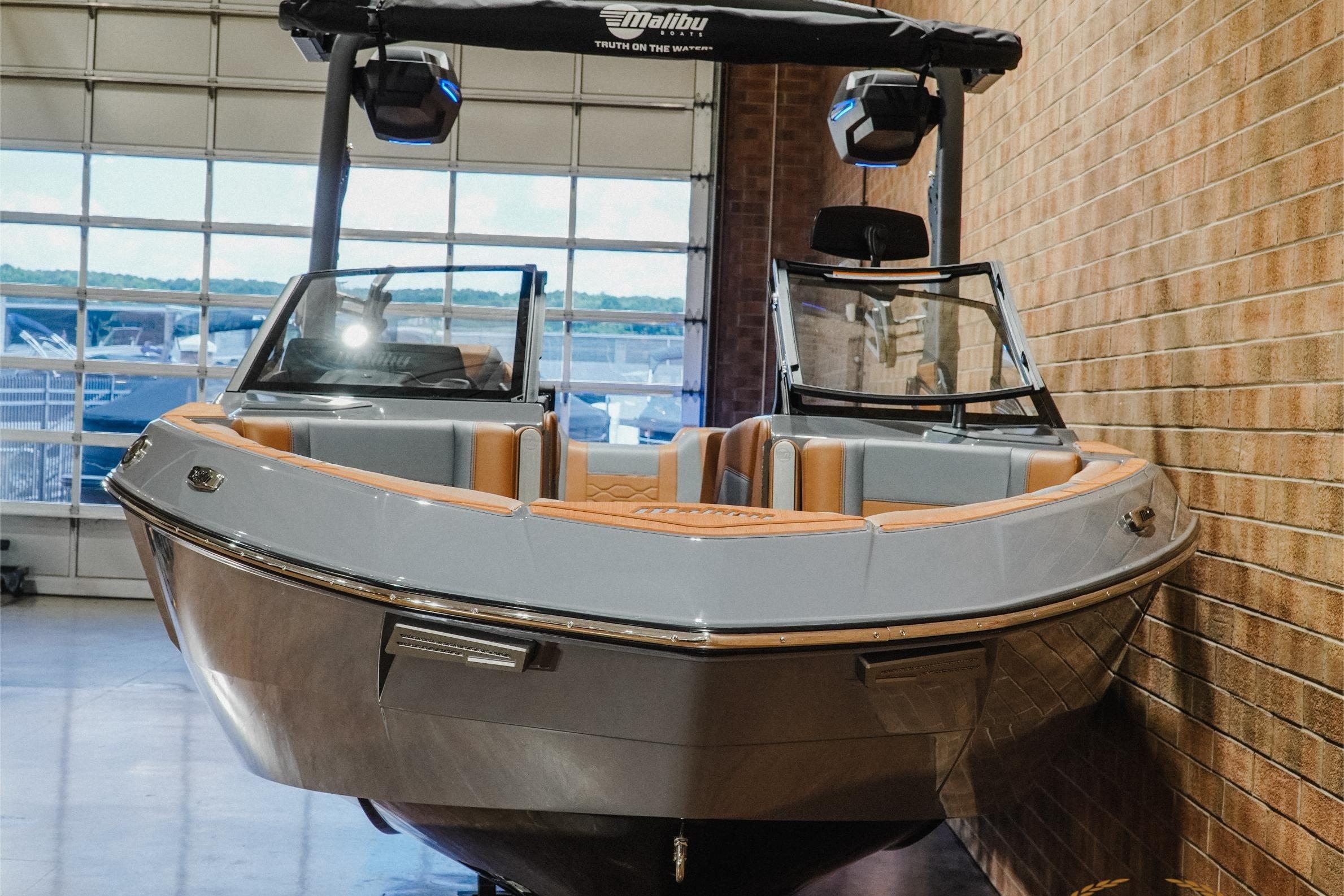 2026 Malibu Wakesetter 23 LSV boat in showroom, featuring sleek design and luxury seating.