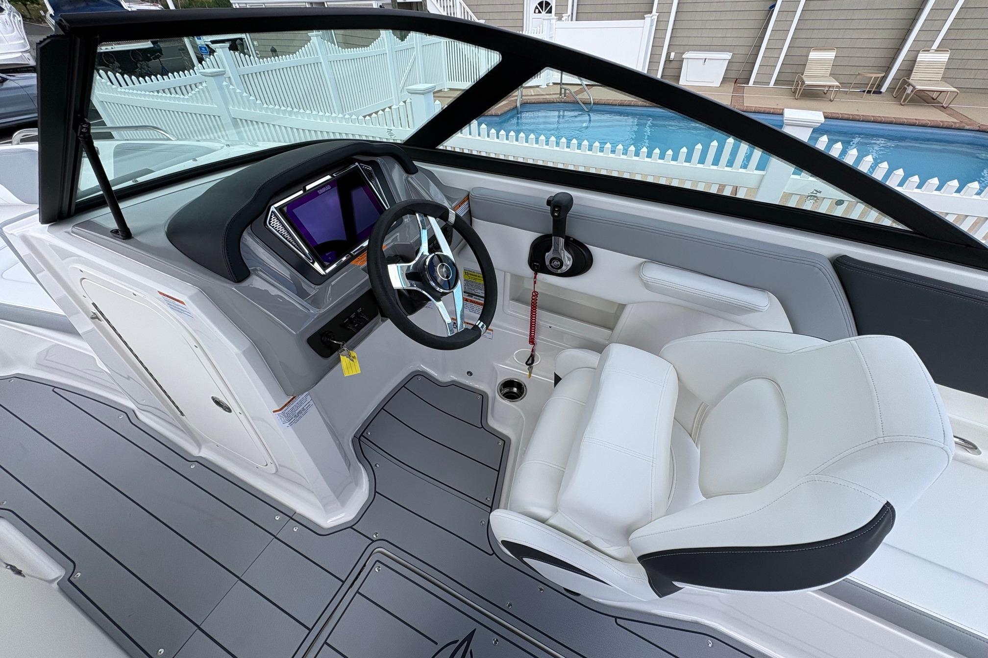 2026 Chaparral 23 SSi OB boat interior with modern dashboard and comfortable seating.