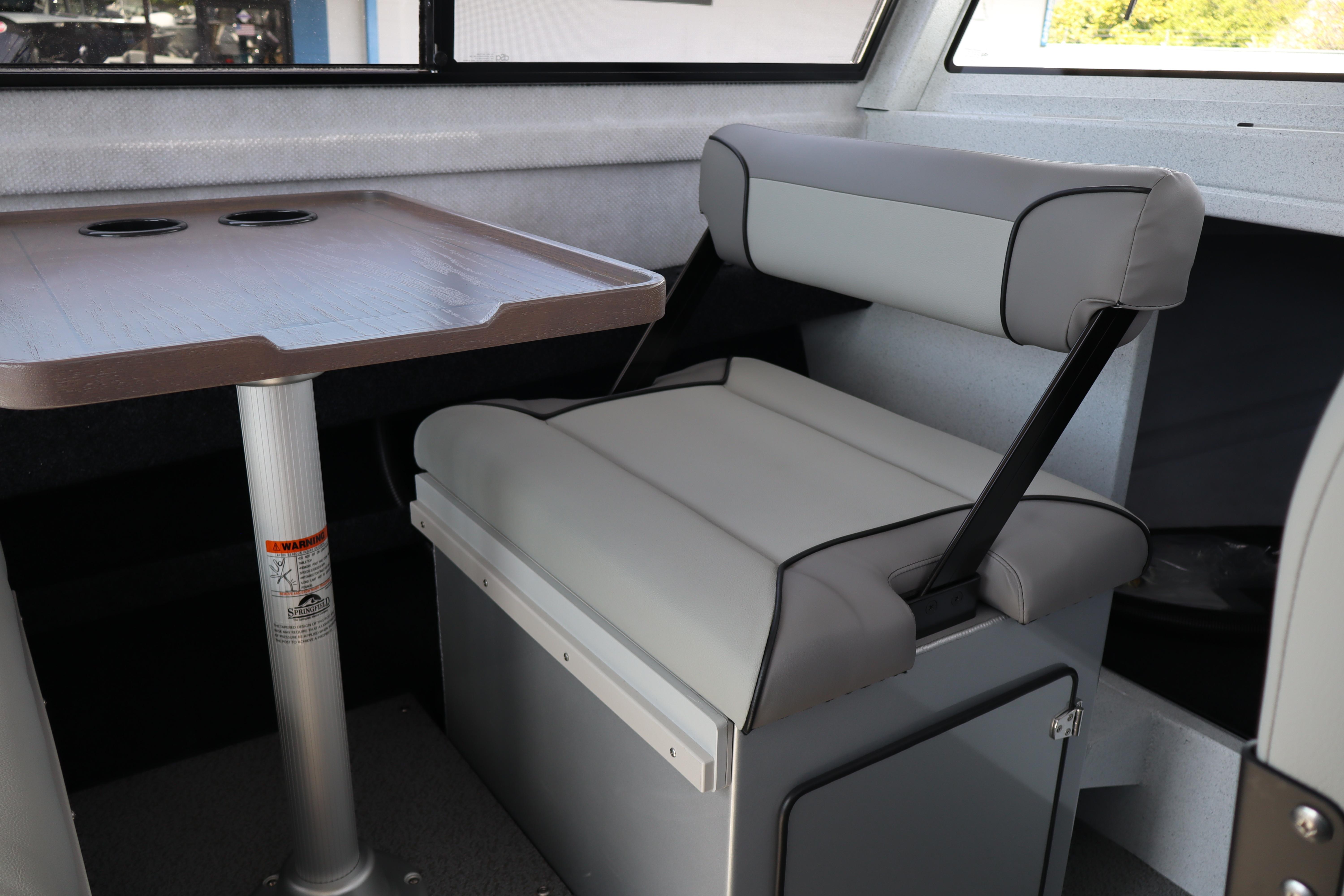 Interior of 2026 KingFisher 25 XAC boat with seating and table.