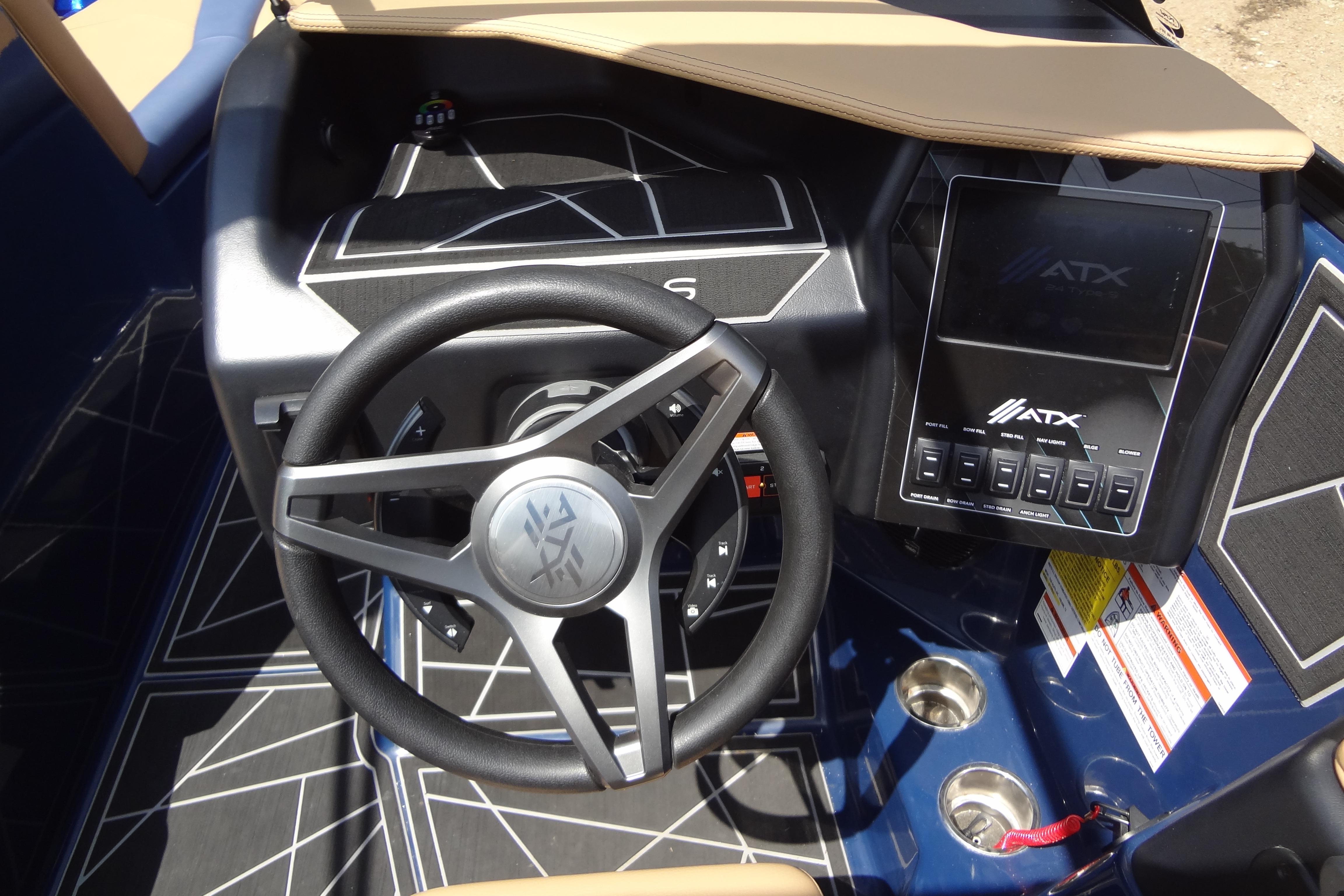 2022 ATX Surf Boats 24 Type-S dashboard with steering wheel and control panel.