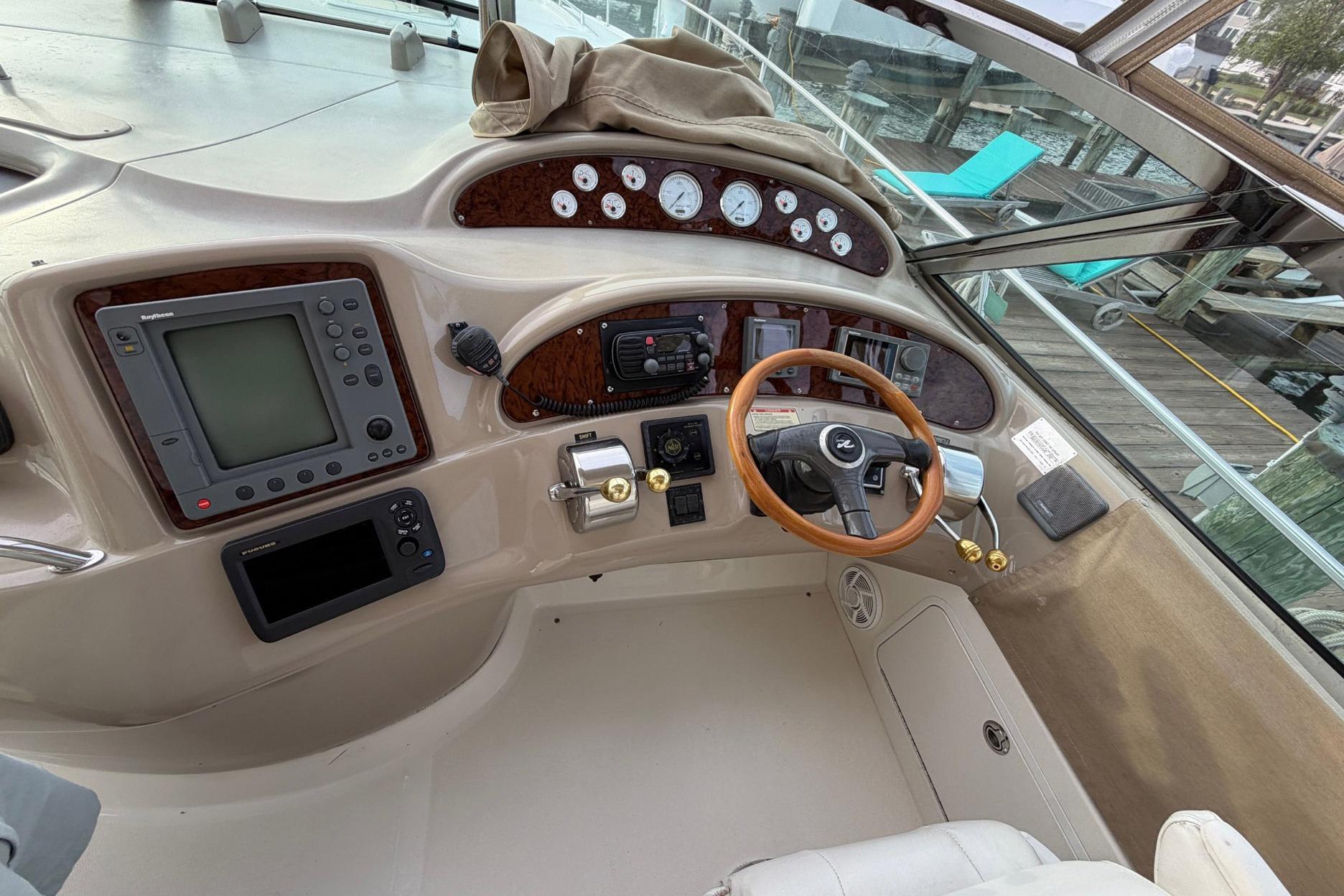 Cockpit of 2000 Sea Ray Sundancer 460 yacht with steering wheel and navigation controls.