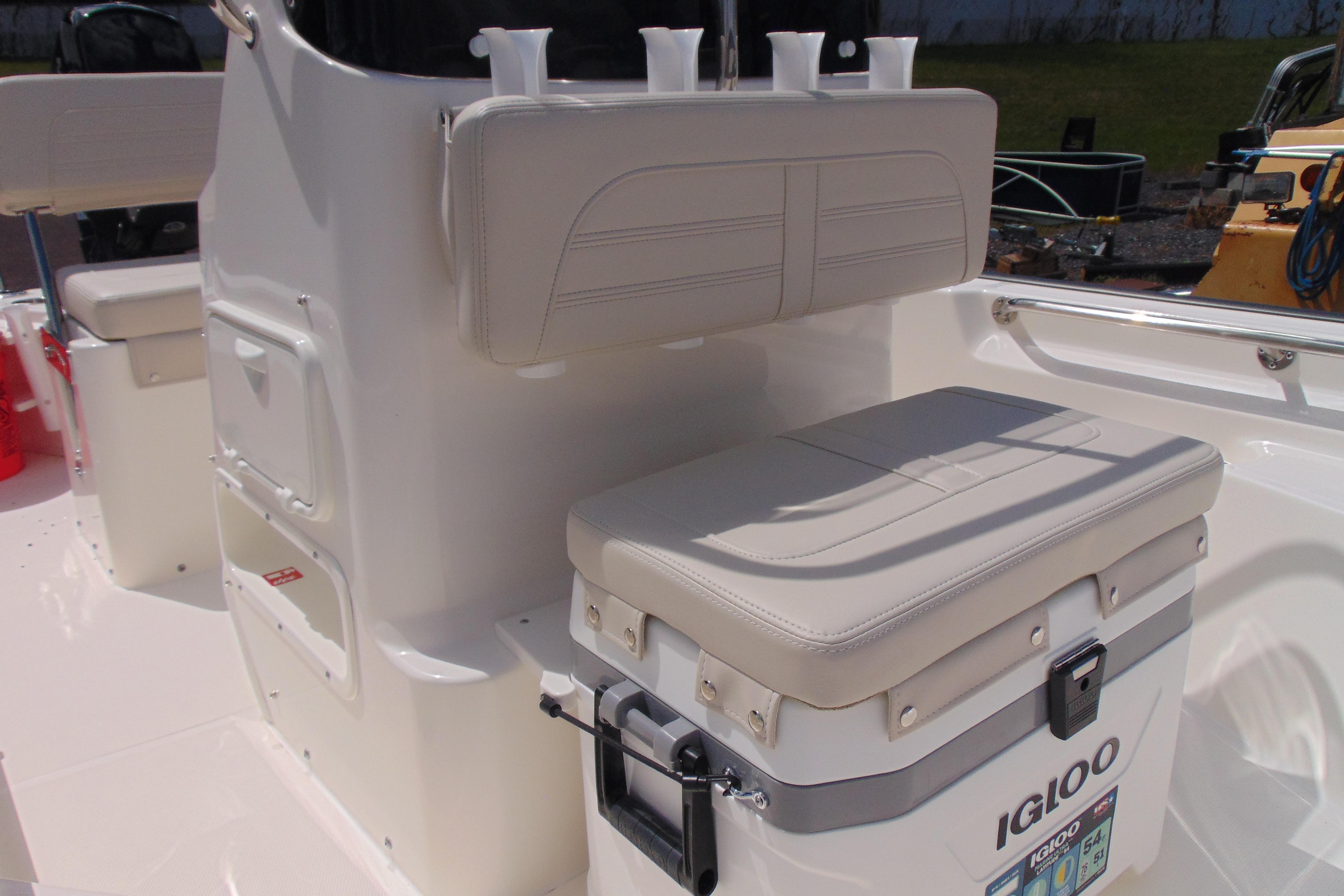 2026 Boston Whaler 150 Montauk boat interior with Igloo cooler and cushioned seating.
