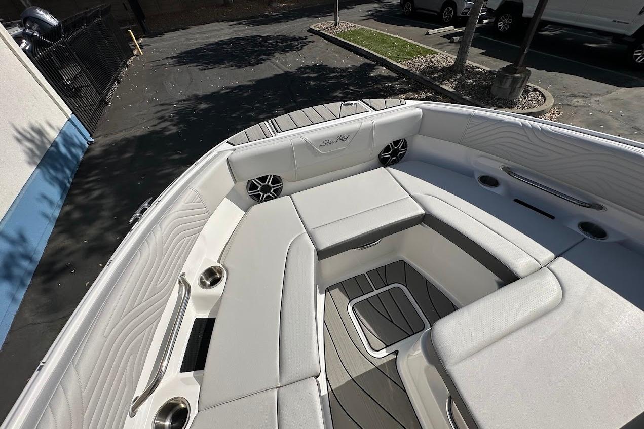 2026 Sea Ray SDX 230 Surf boat interior with white seating and cup holders.