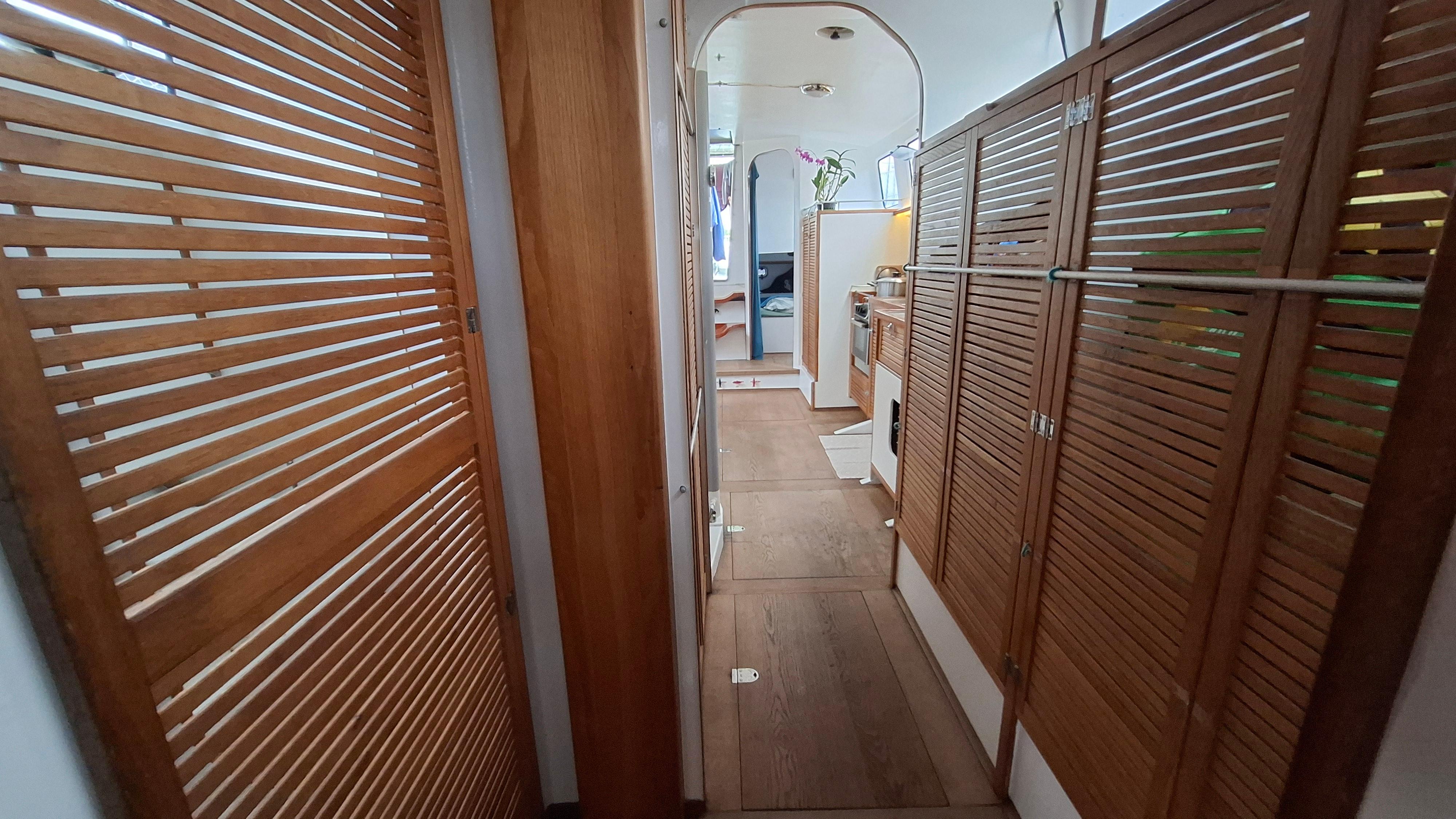 Interior hallway of a 2018 Custom Cutter 48 yacht with wooden paneling.