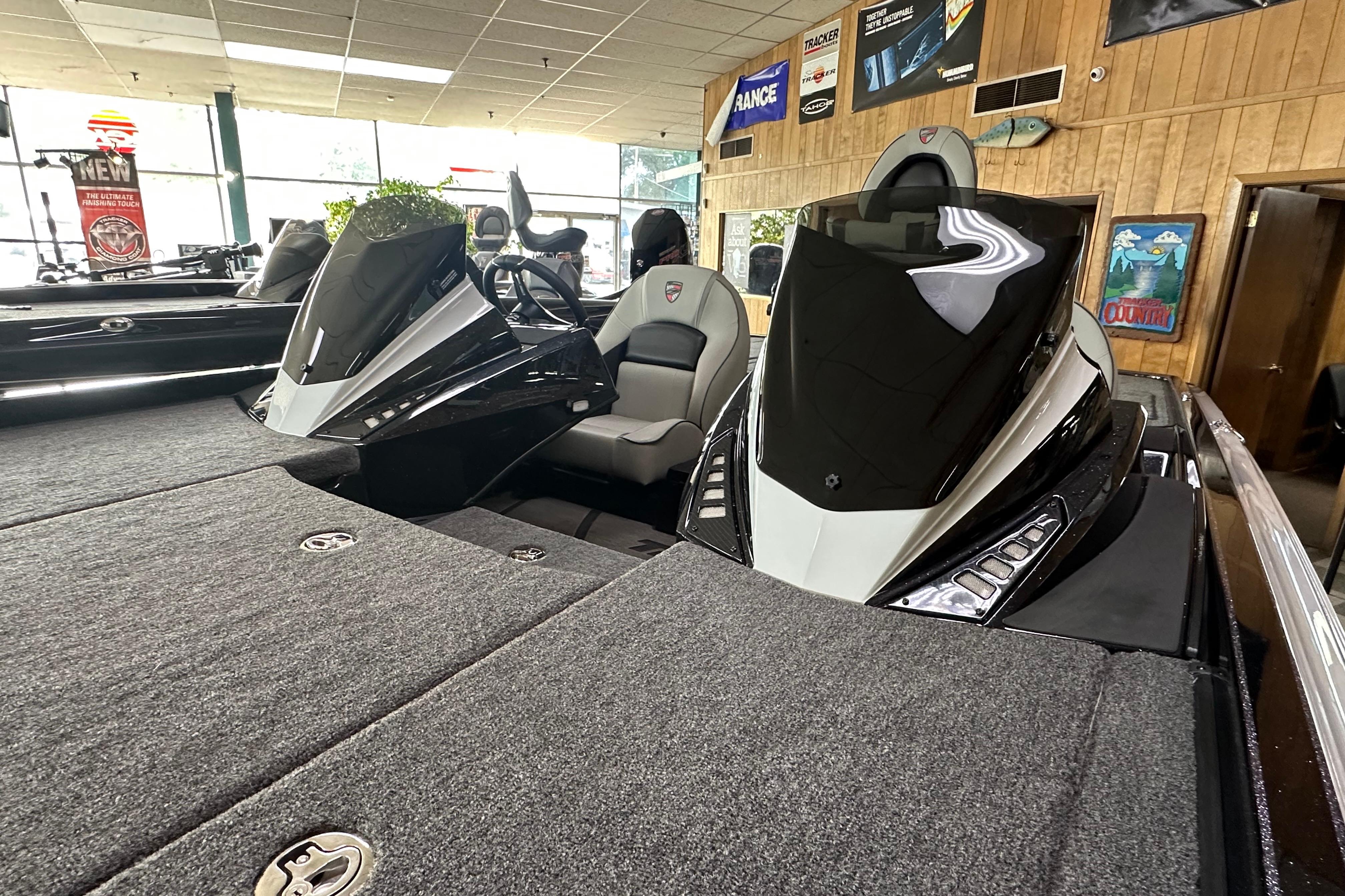 2024 Triton 20XP Patriot boat interior with dual consoles and seating in showroom.