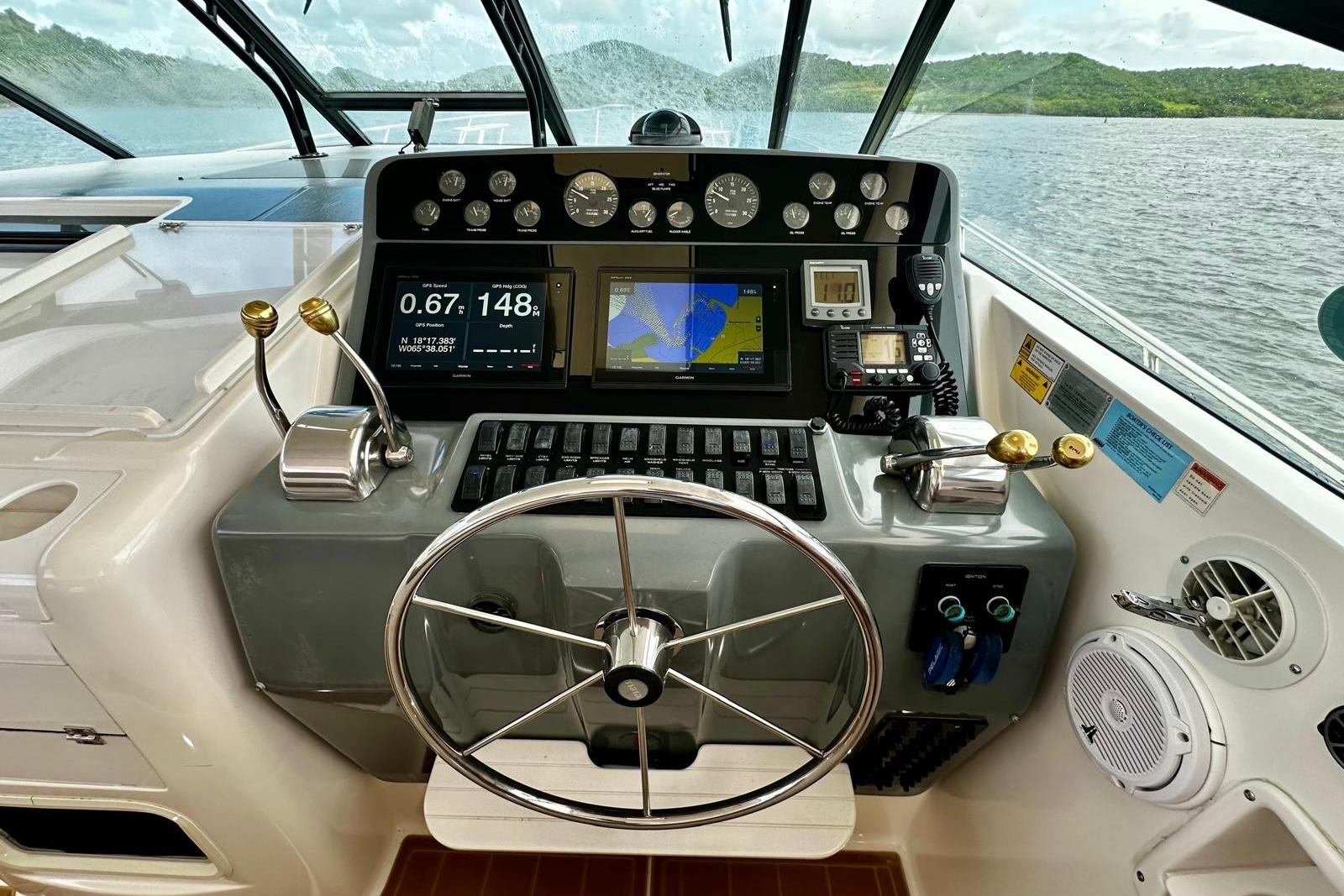 Helm of 2003 Tiara Yachts 4000 Express with navigation instruments and steering wheel.