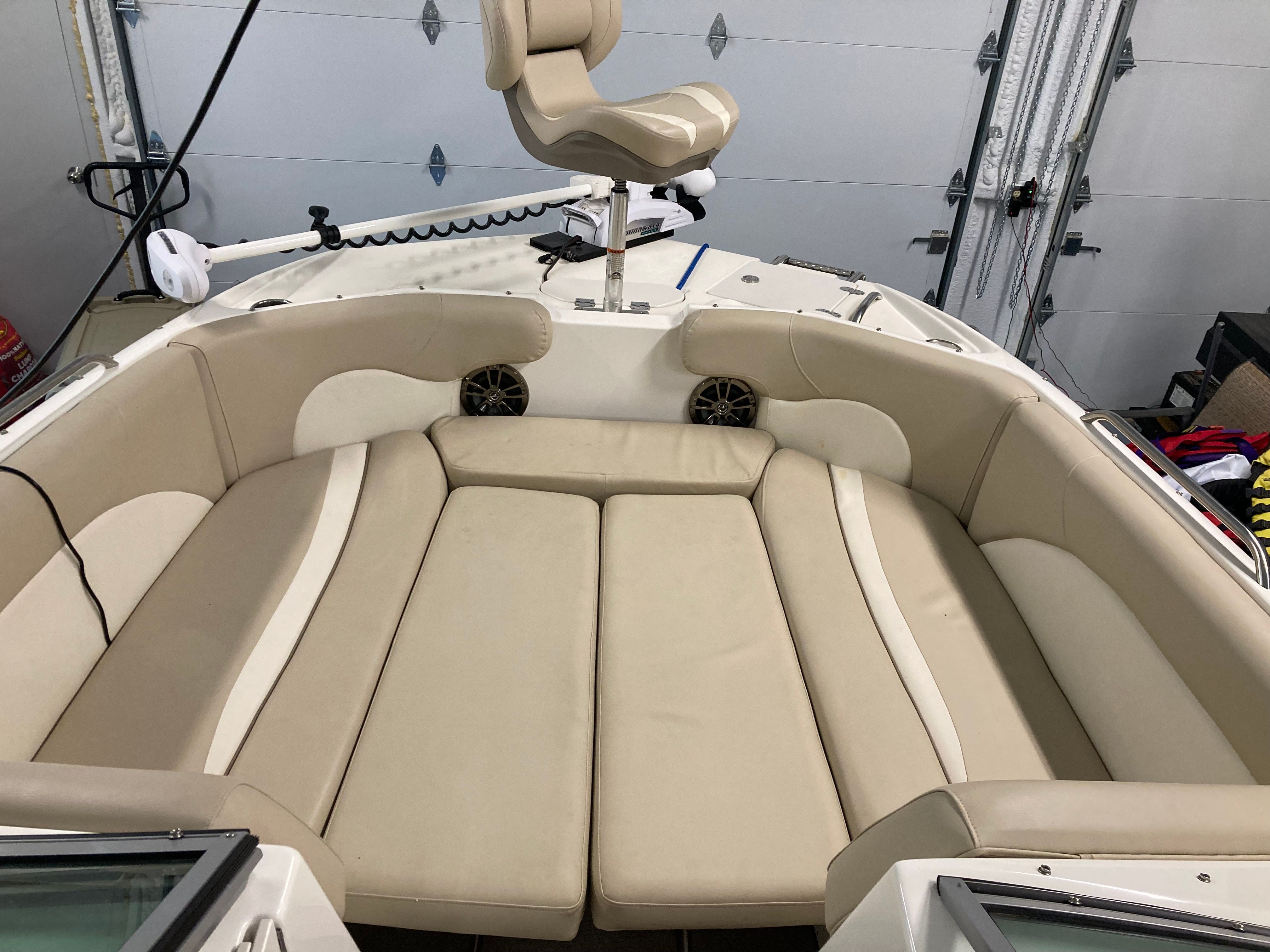 Interior view of a 2016 Custom 223 DC boat with beige upholstery.
