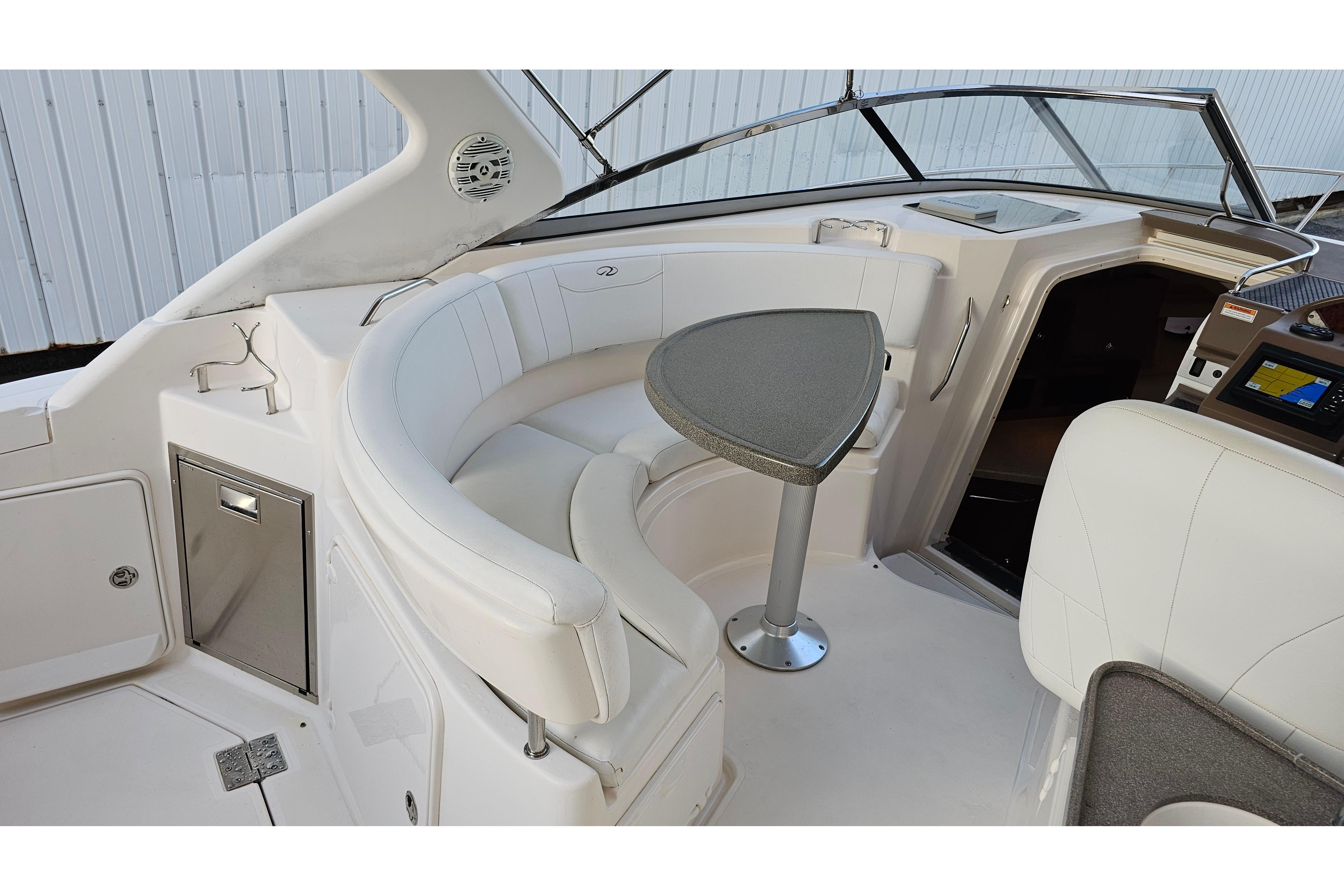 2005 Regal 3060 Window Express boat interior with curved seating and table.