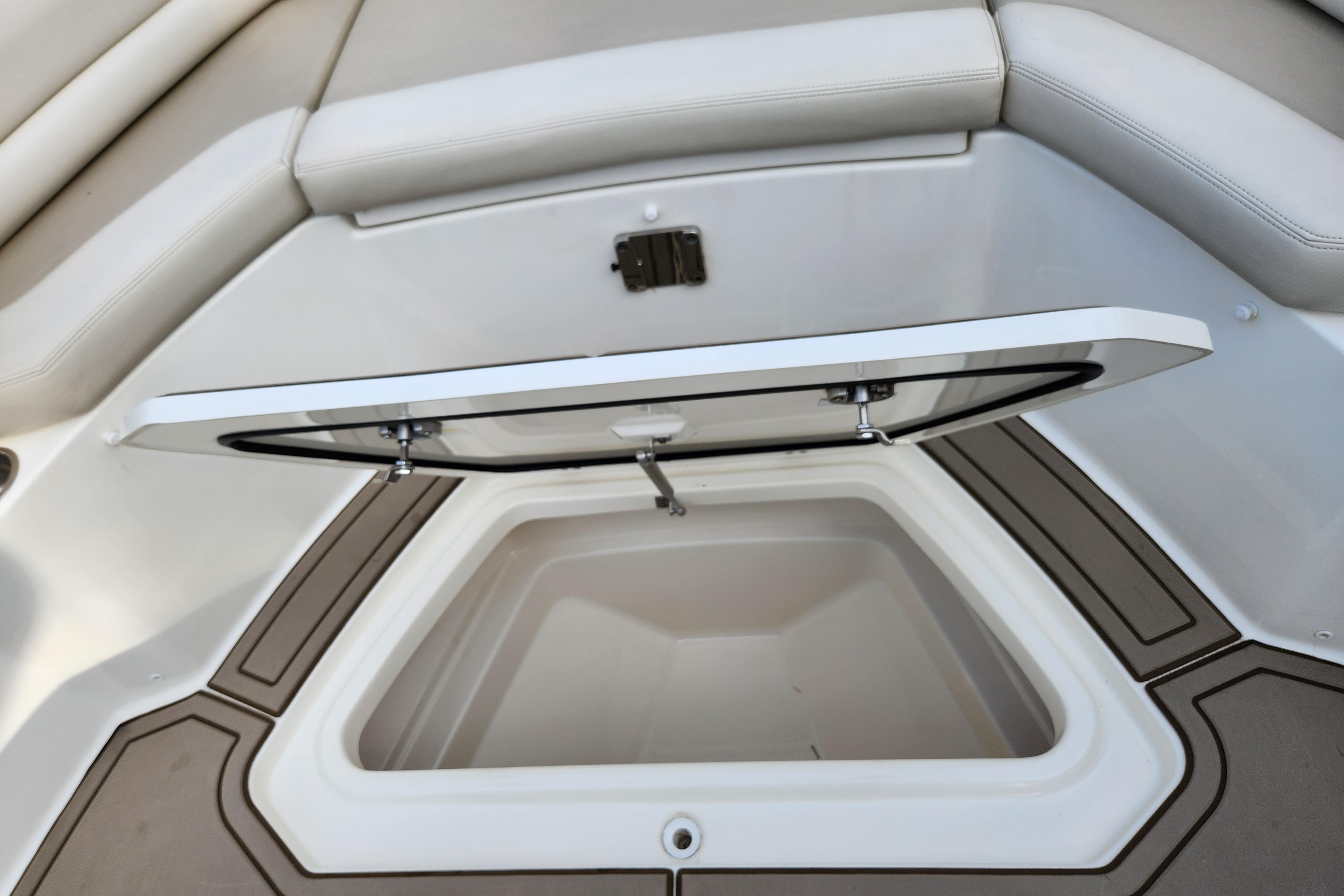 2022 Boston Whaler 330 Outrage storage compartment with open hatch, showcasing interior space.