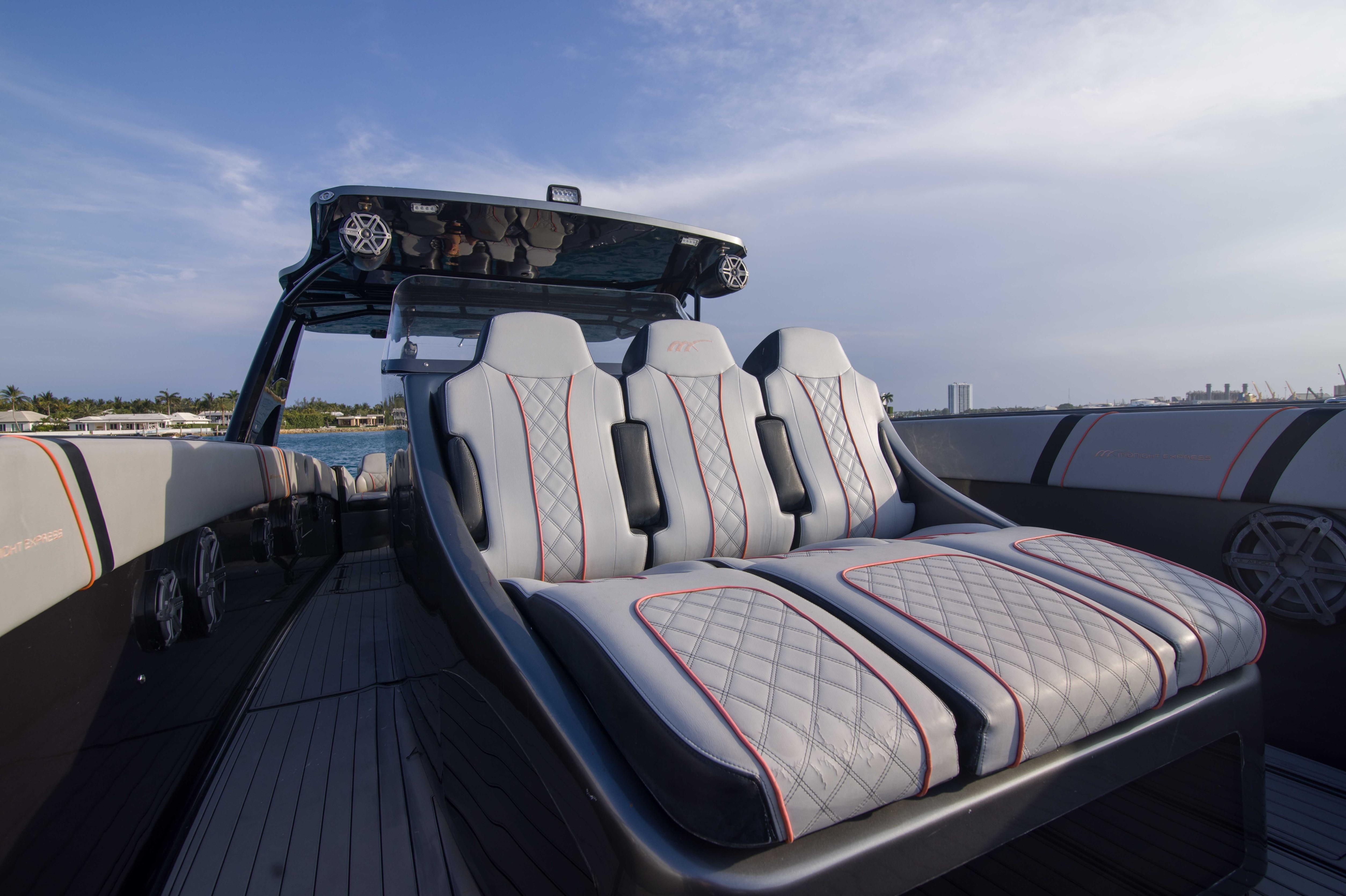 Luxurious seating on a 2019 Midnight Express 43 Open boat, featuring sleek design and waterfront view.