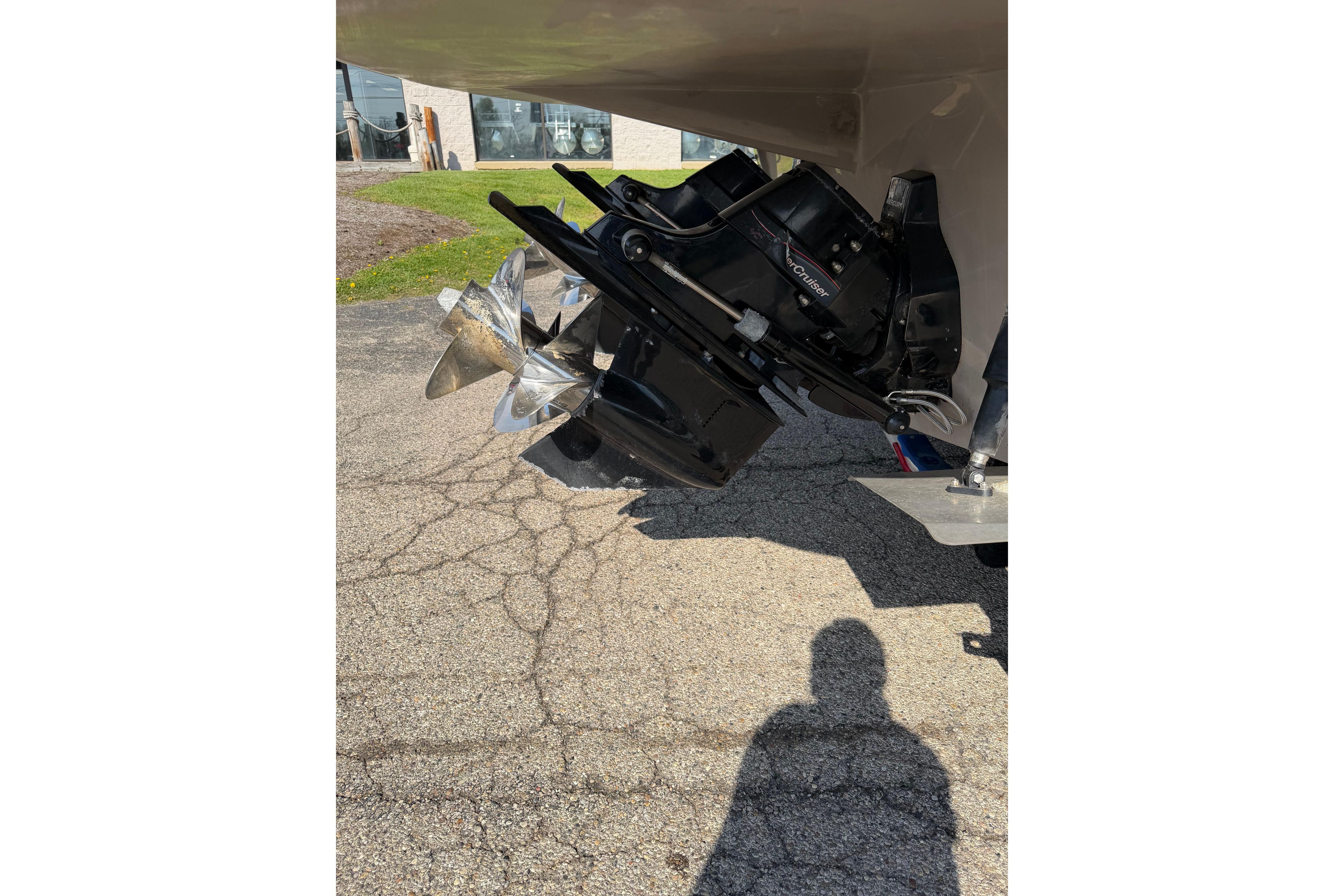 2019 Rinker EX 320 boat propeller and drive system on pavement.