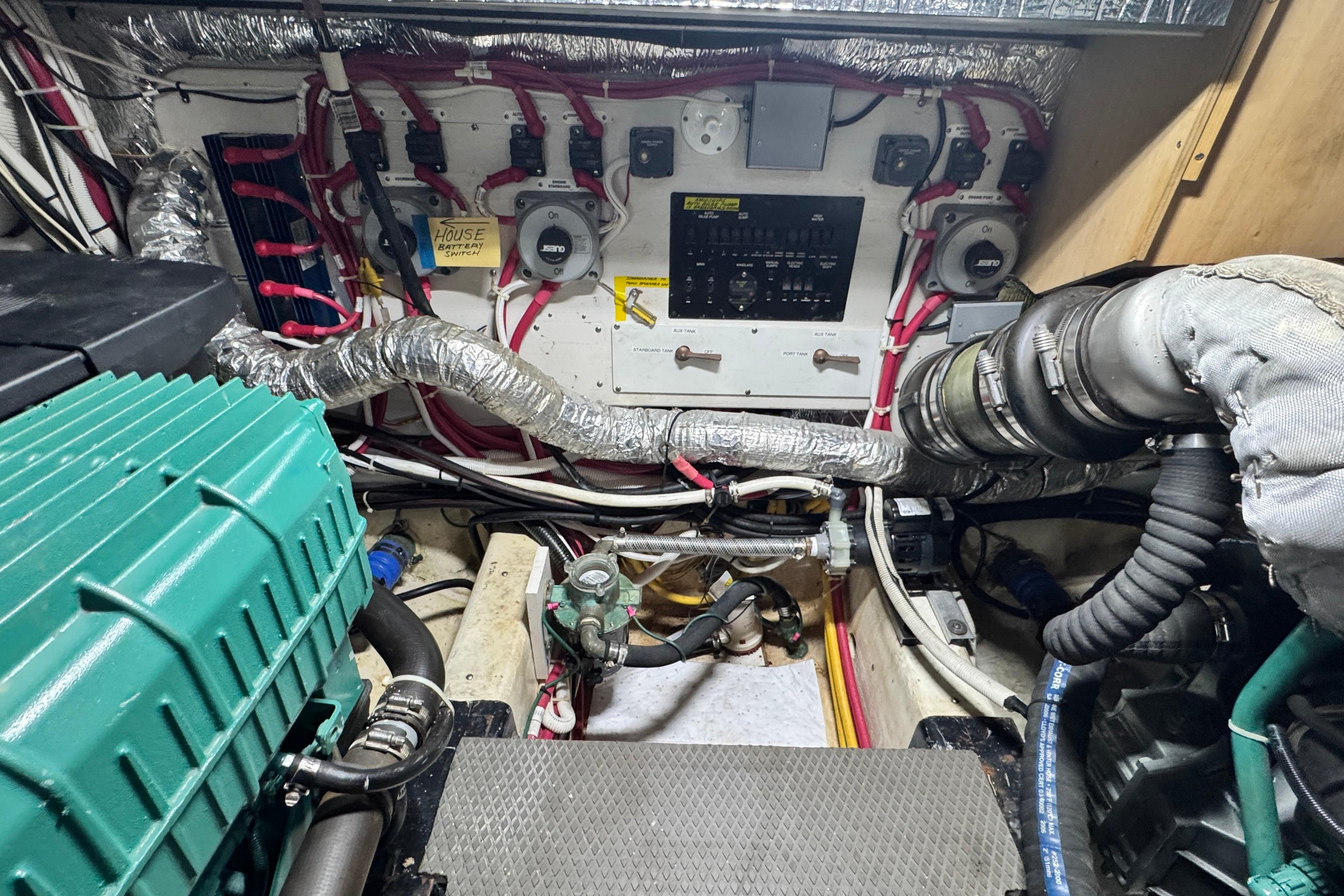 Engine room of 2007 Carver 47 Motor Yacht with wiring and machinery.