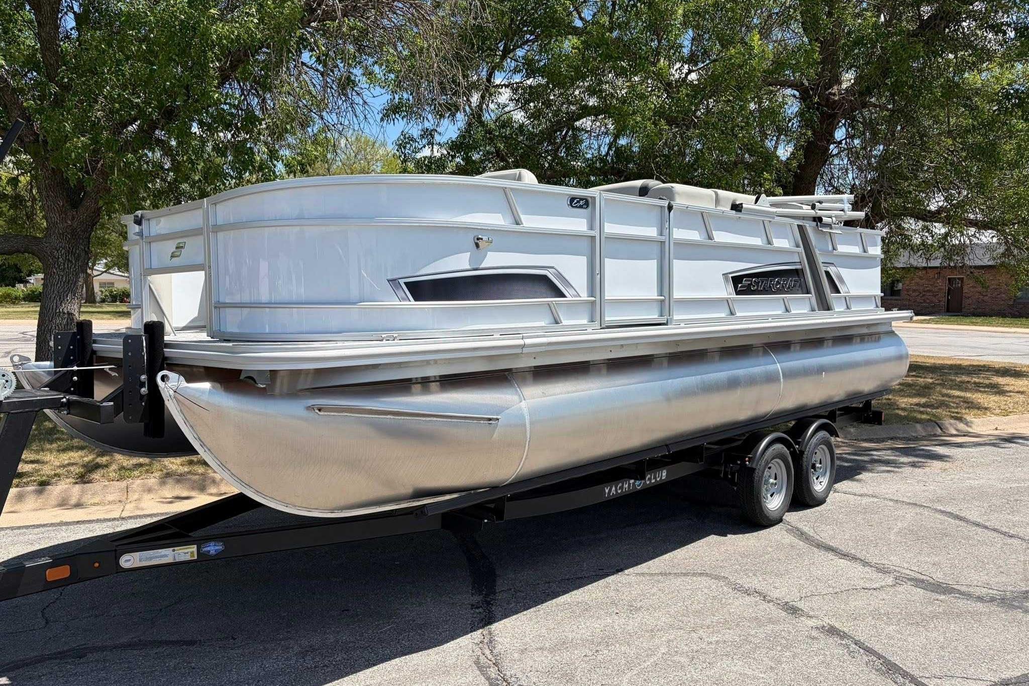 2026 Starcraft EX 22 FD4 pontoon boat on trailer, parked outdoors.
