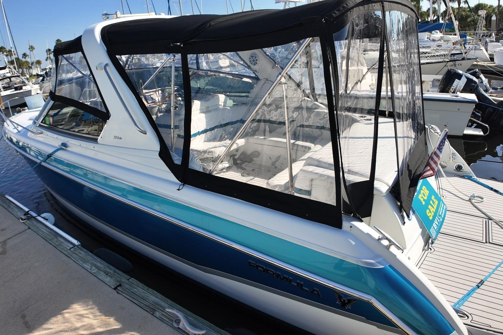 2007 Formula 330 Sun Sport boat docked, featuring a sleek design and "For Sale" sign.