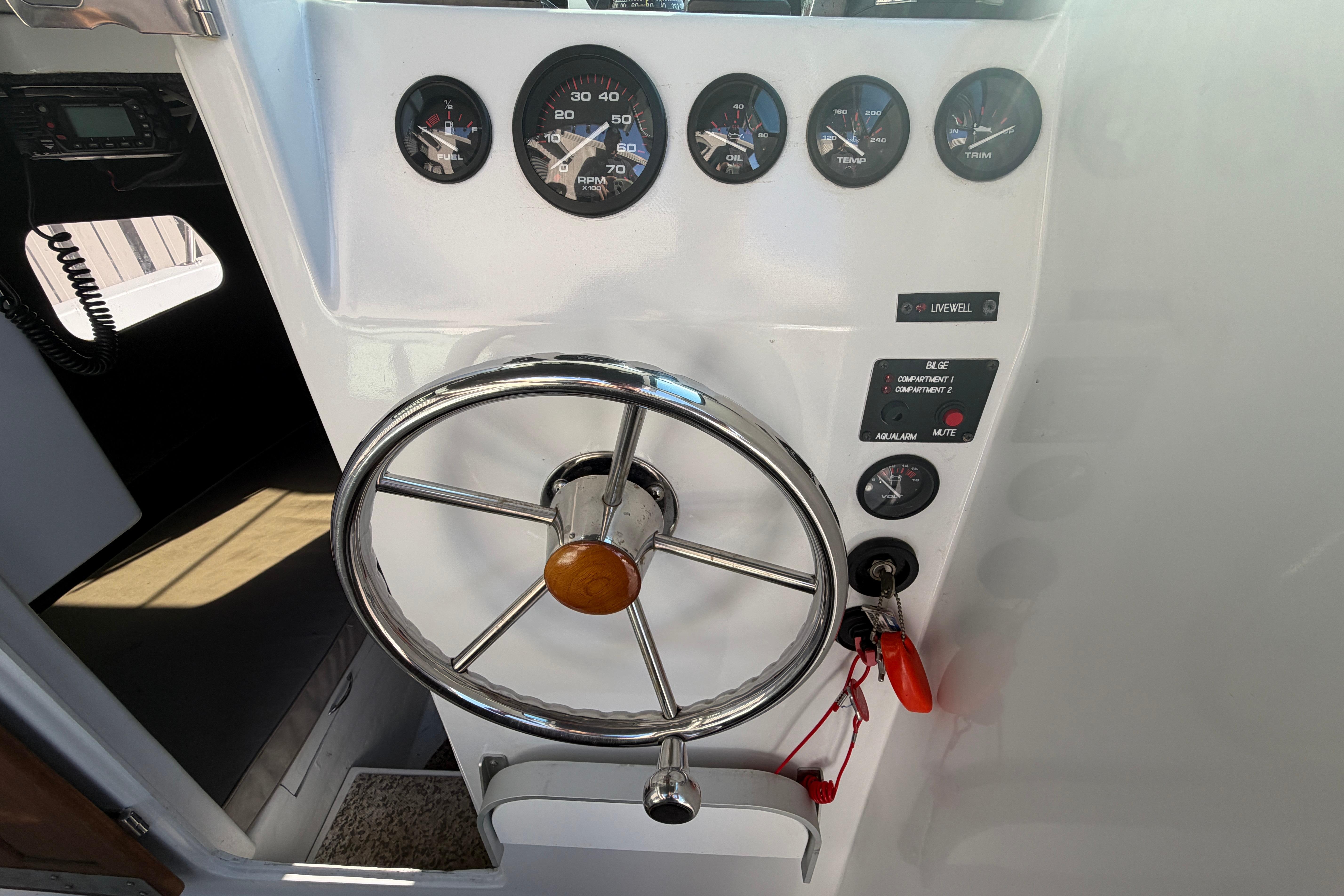 1986 Radon 21 Sport boat dashboard with steering wheel and gauges.