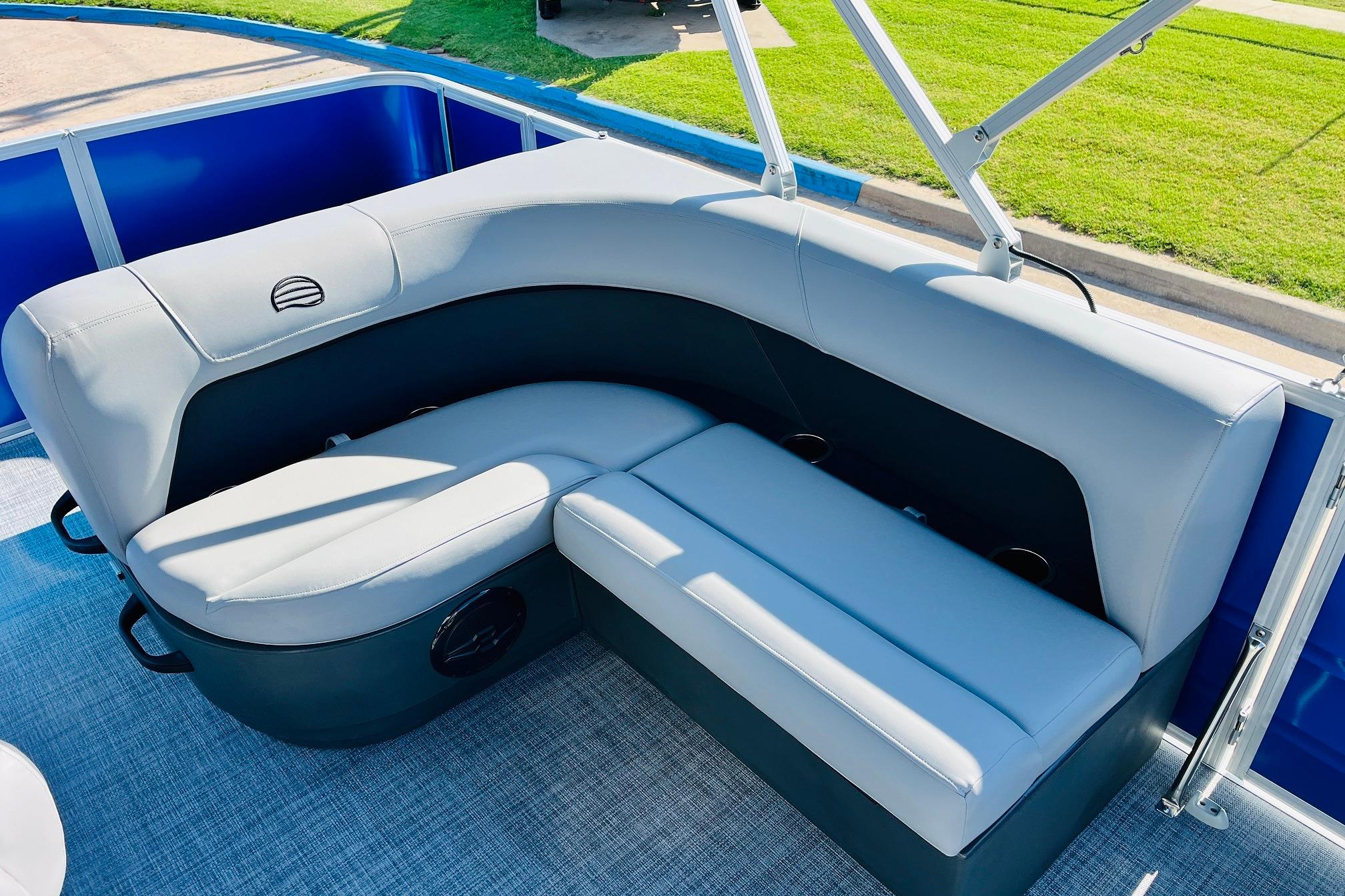 2026 Sun Tracker Party Barge 18 DLX interior seating with gray upholstery and blue accents.
