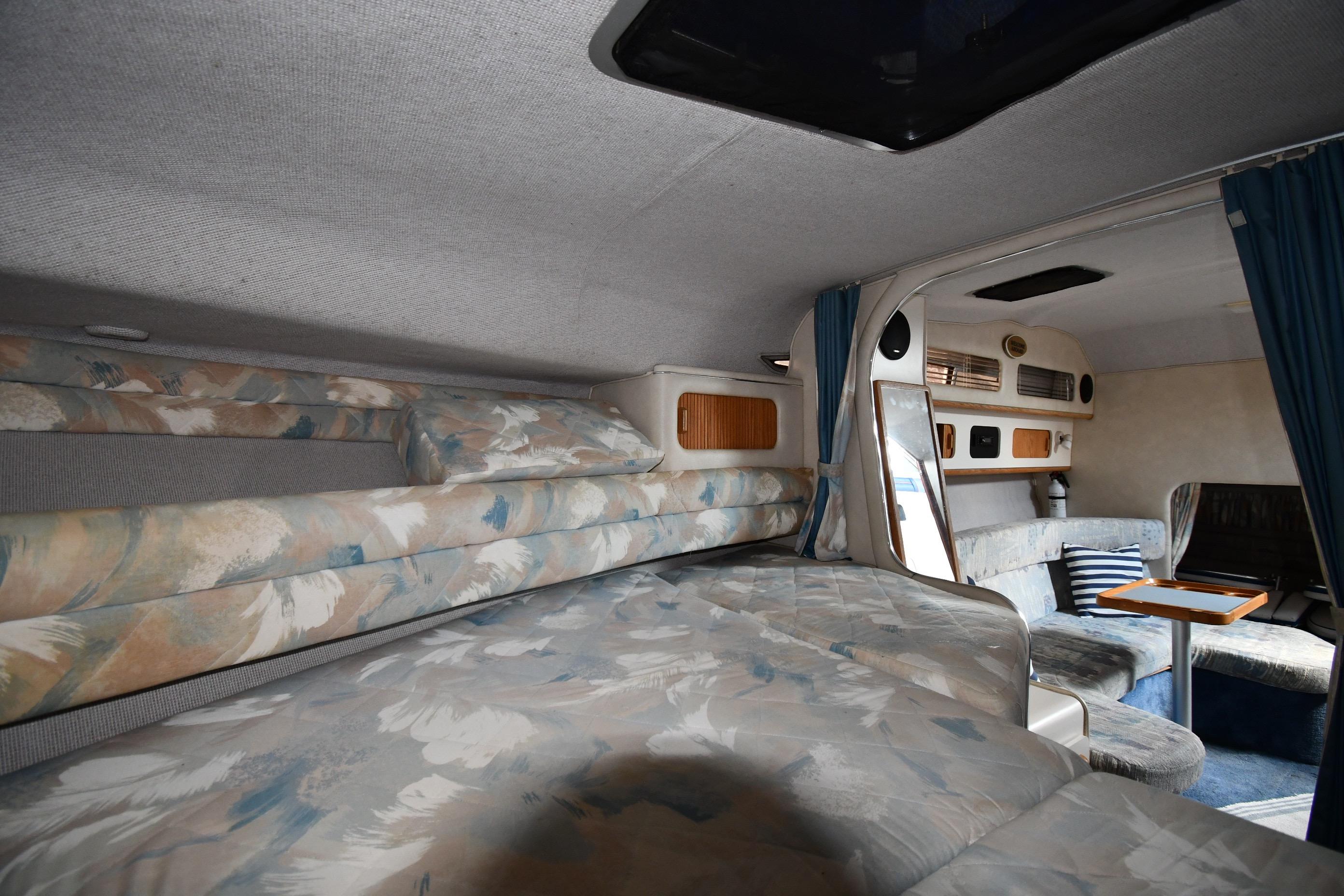 Interior of 1993 Sea Ray 300 Sundancer with cozy sleeping and seating areas.