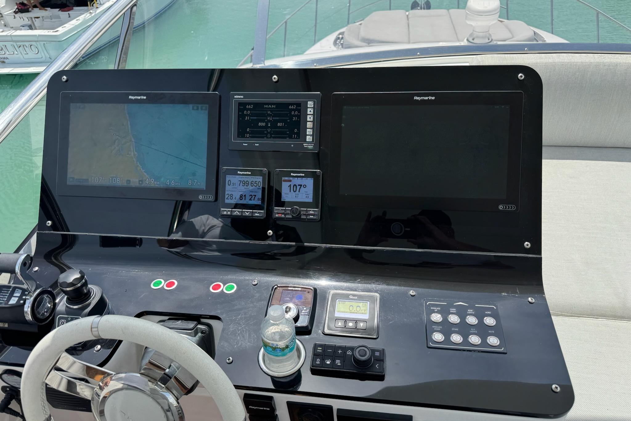 Control panel of a 2021 Azimut 55 yacht with navigation screens.