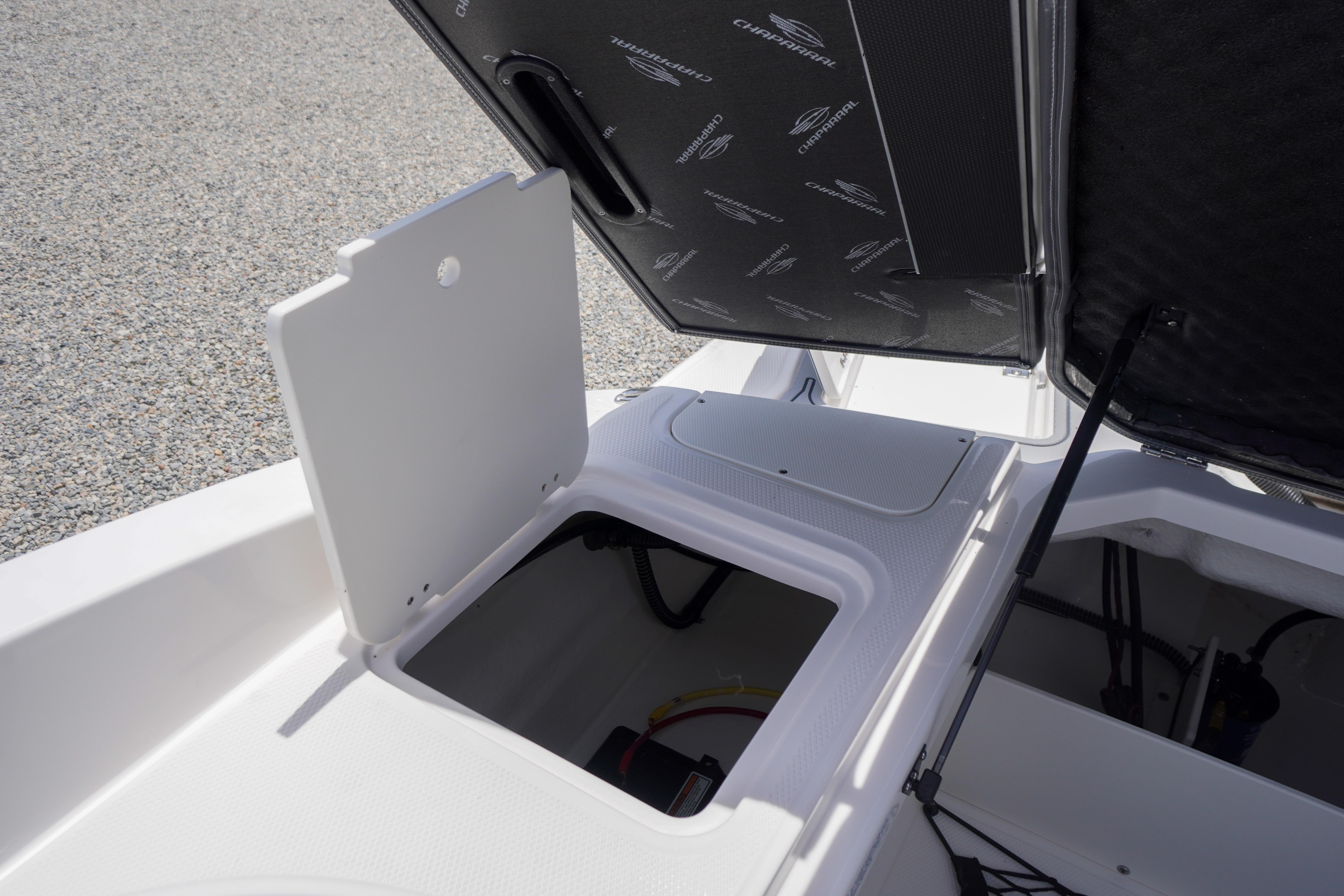 2026 Chaparral 23 SSi OB boat storage compartment with open hatch.
