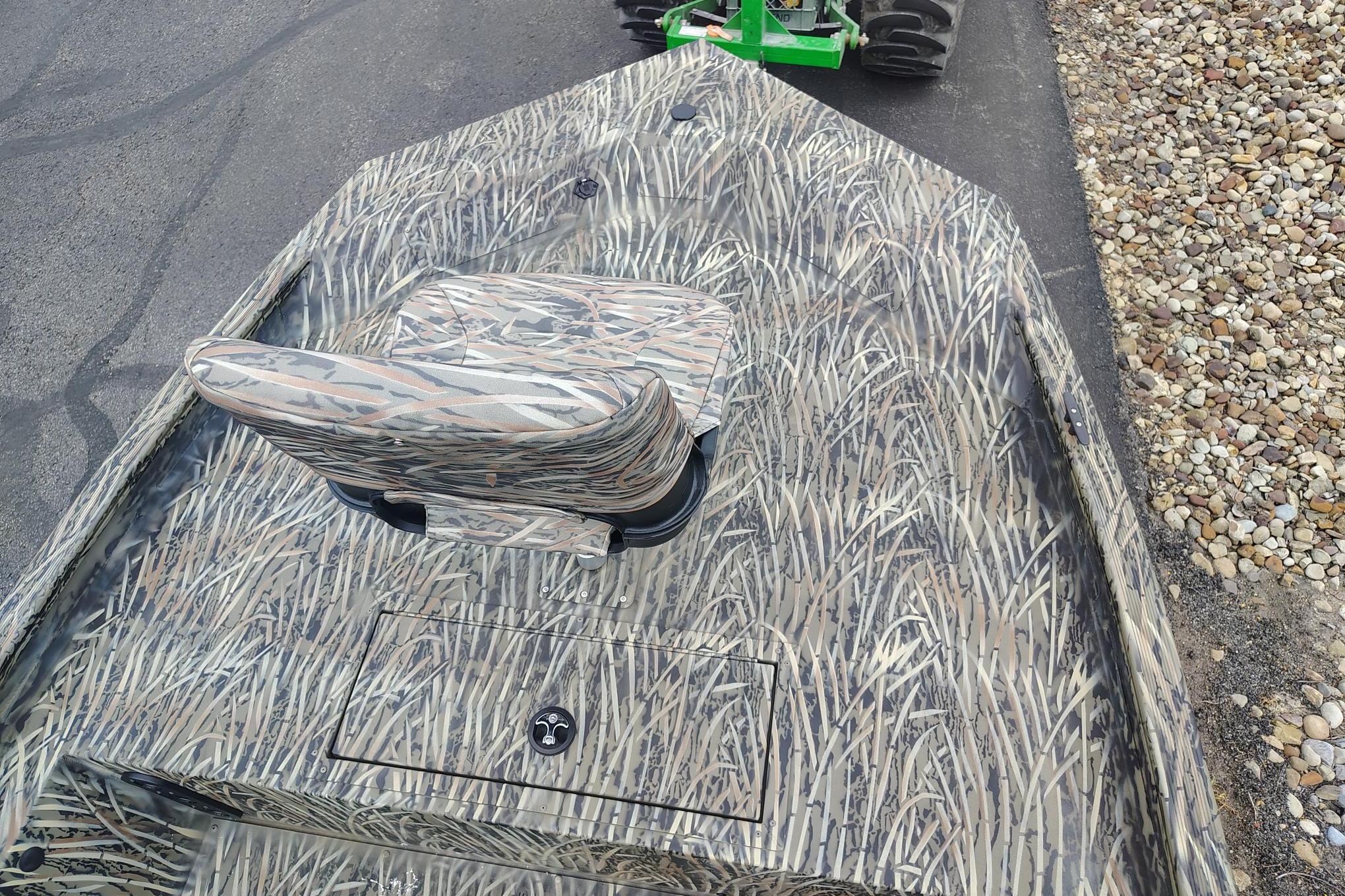 2026 Tracker Grizzly 1754 SC boat with camouflage pattern on a paved surface.