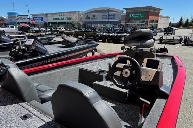 2026 Tracker Pro Team 175 boat interior at outdoor dealership, featuring steering console and seating.