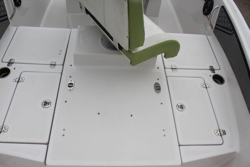 Interior of a 2017 Scarab 195 boat featuring white storage compartments and a green seat.