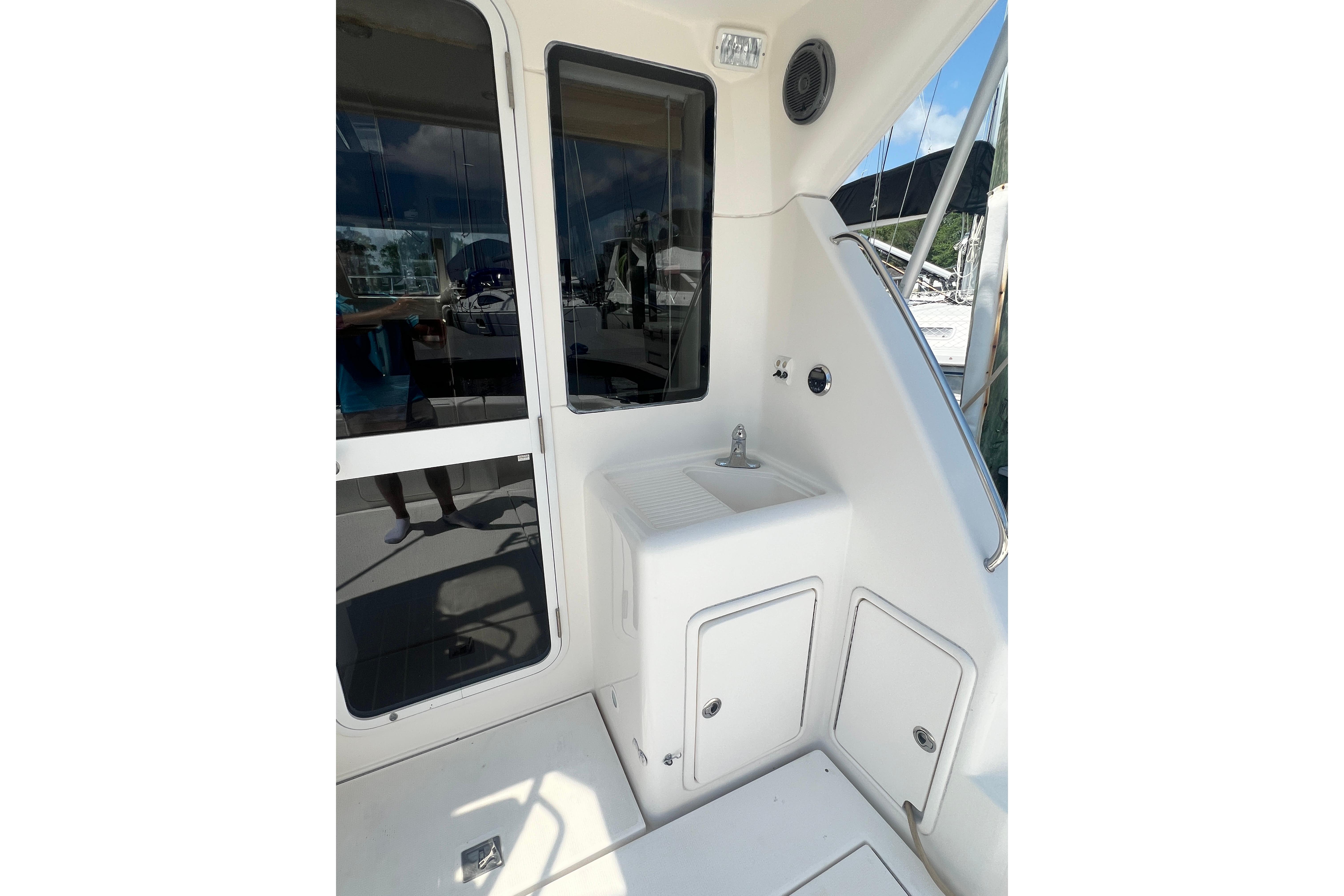 2007 Riviera 33 Flybridge yacht interior with sink and storage compartments.