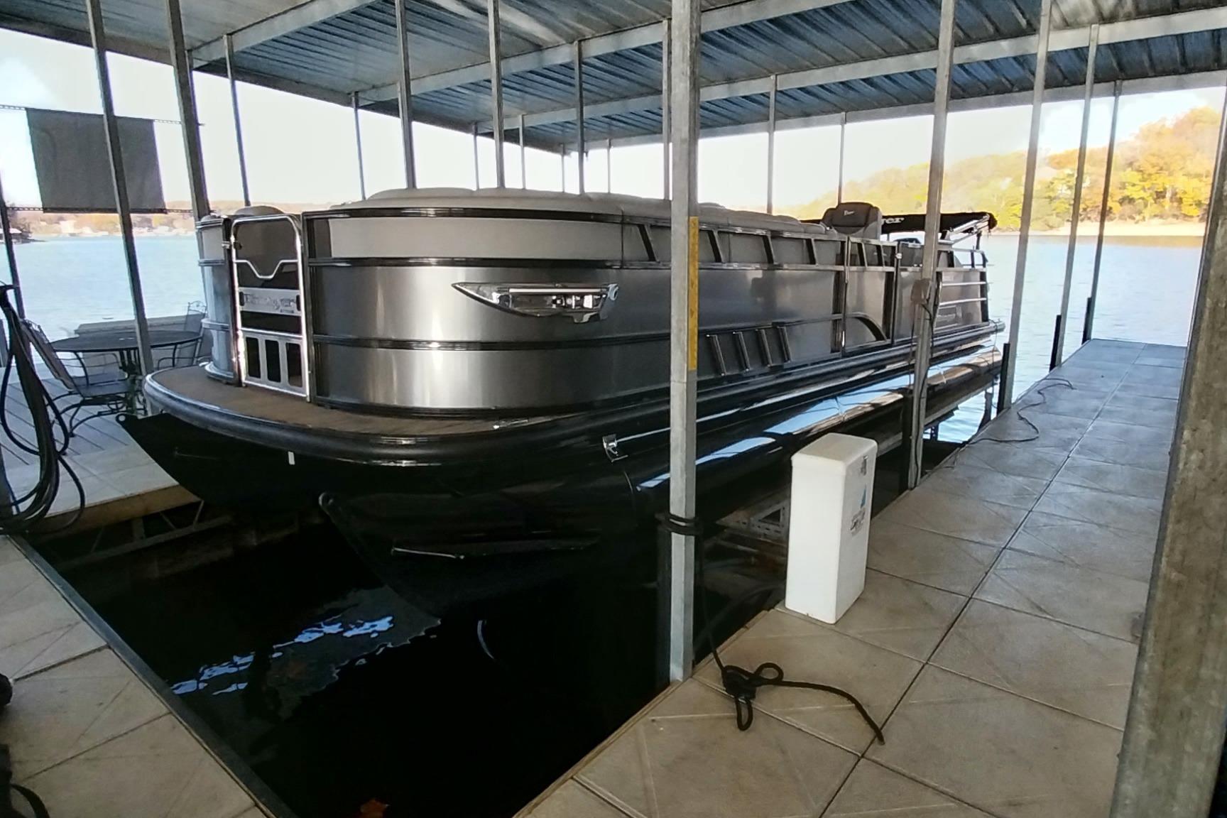 2023 Ranger 2500LS pontoon boat docked under a covered marina.