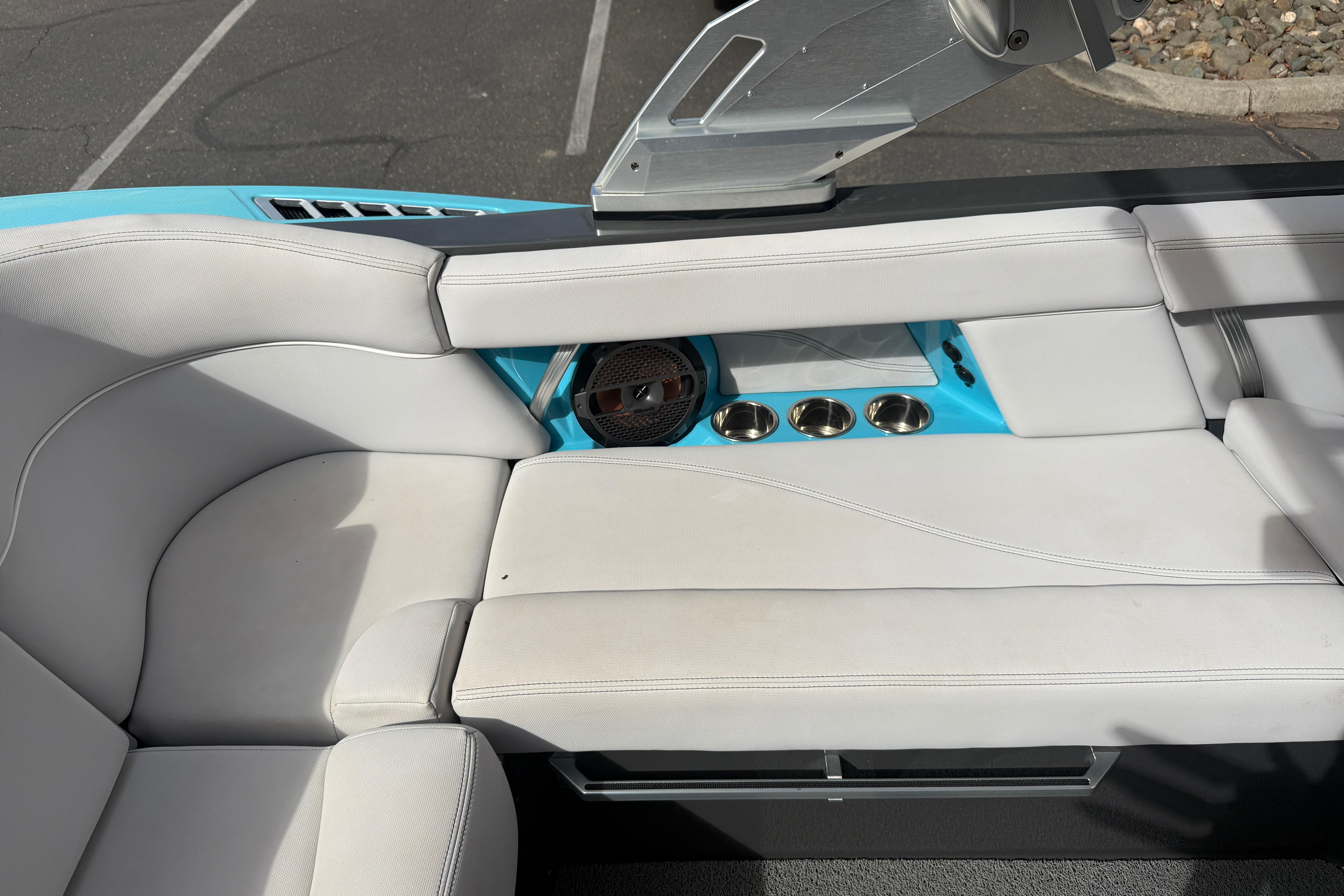 2018 MasterCraft XT21 boat interior with white seating and blue accents.