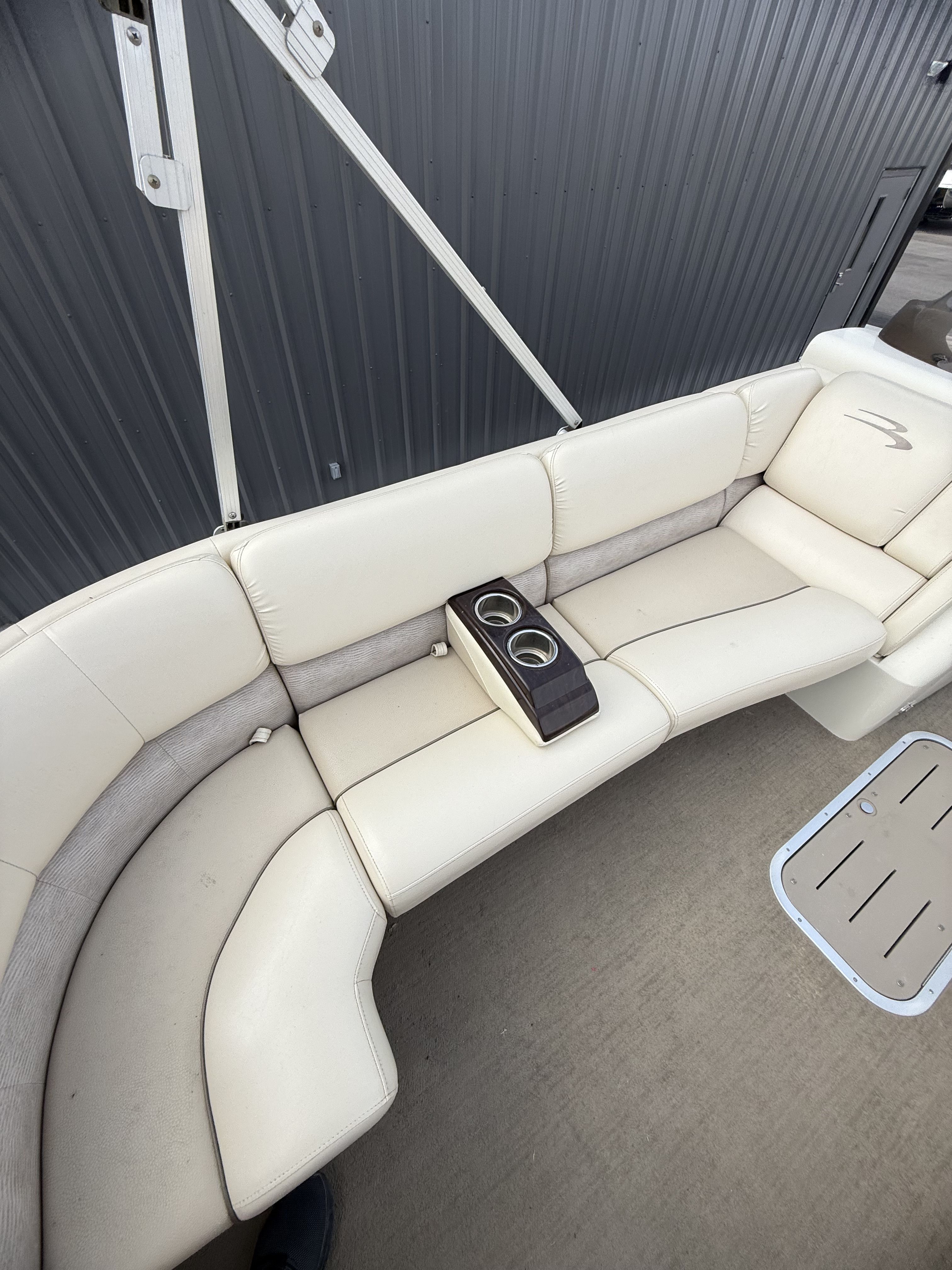 Interior of a 2014 Bennington 2575RCW-I/O with white leather seating.