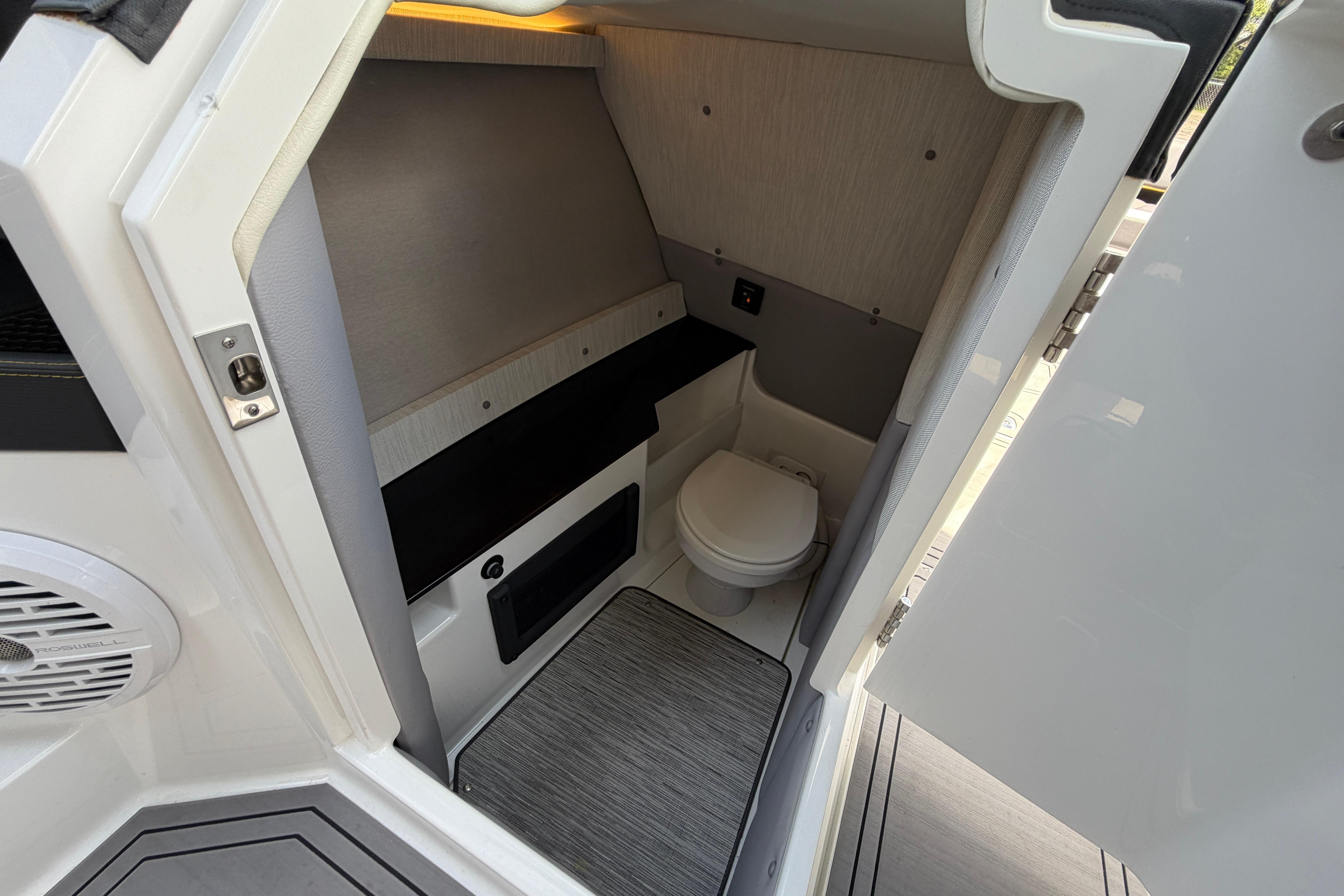 Interior of 2021 Cobalt R8 Surf boat featuring a compact, modern bathroom.