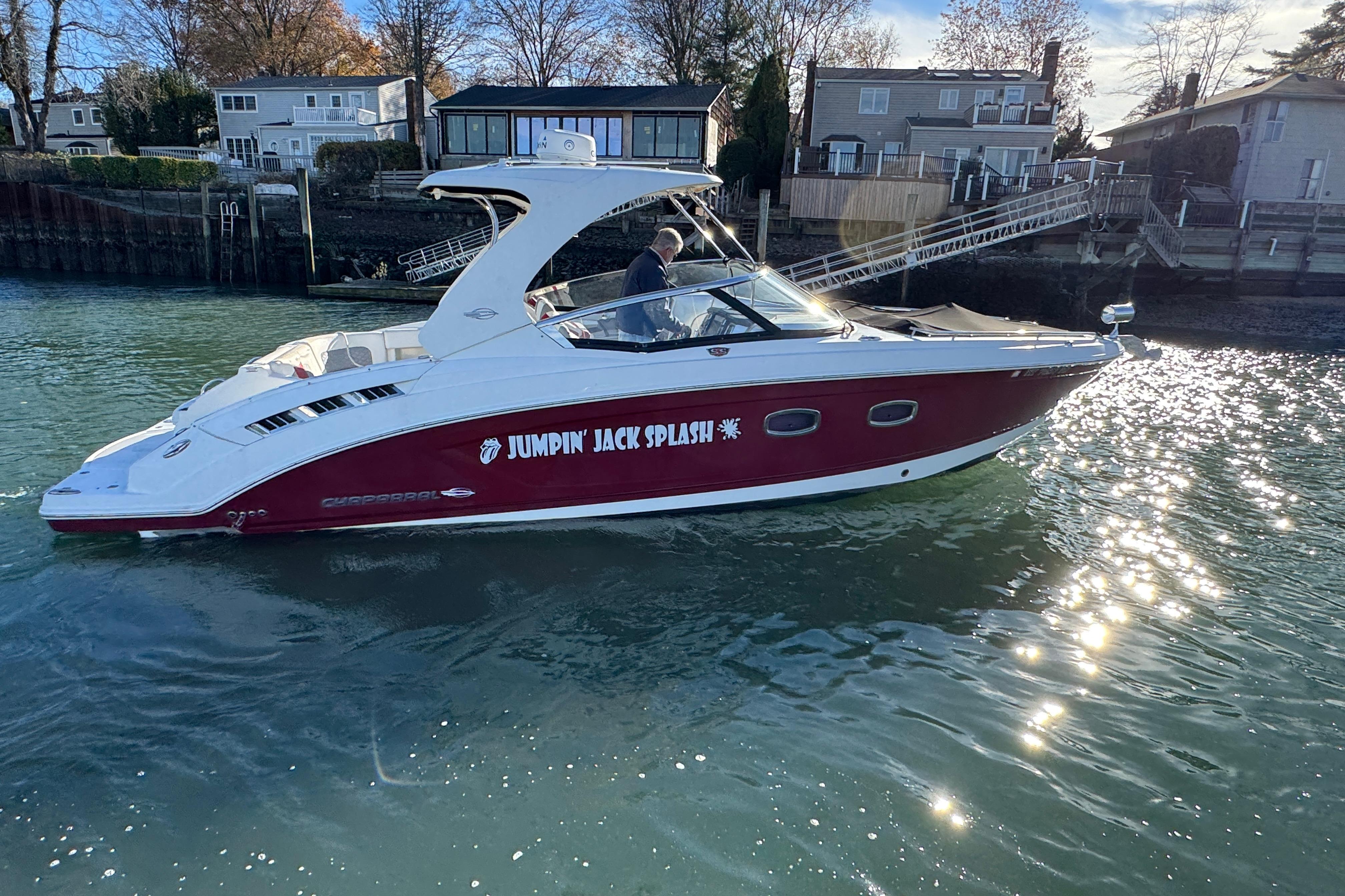 2012 Chaparral 327 SSX boat named "Jumpin' Jack Splash" on a sunny waterway.