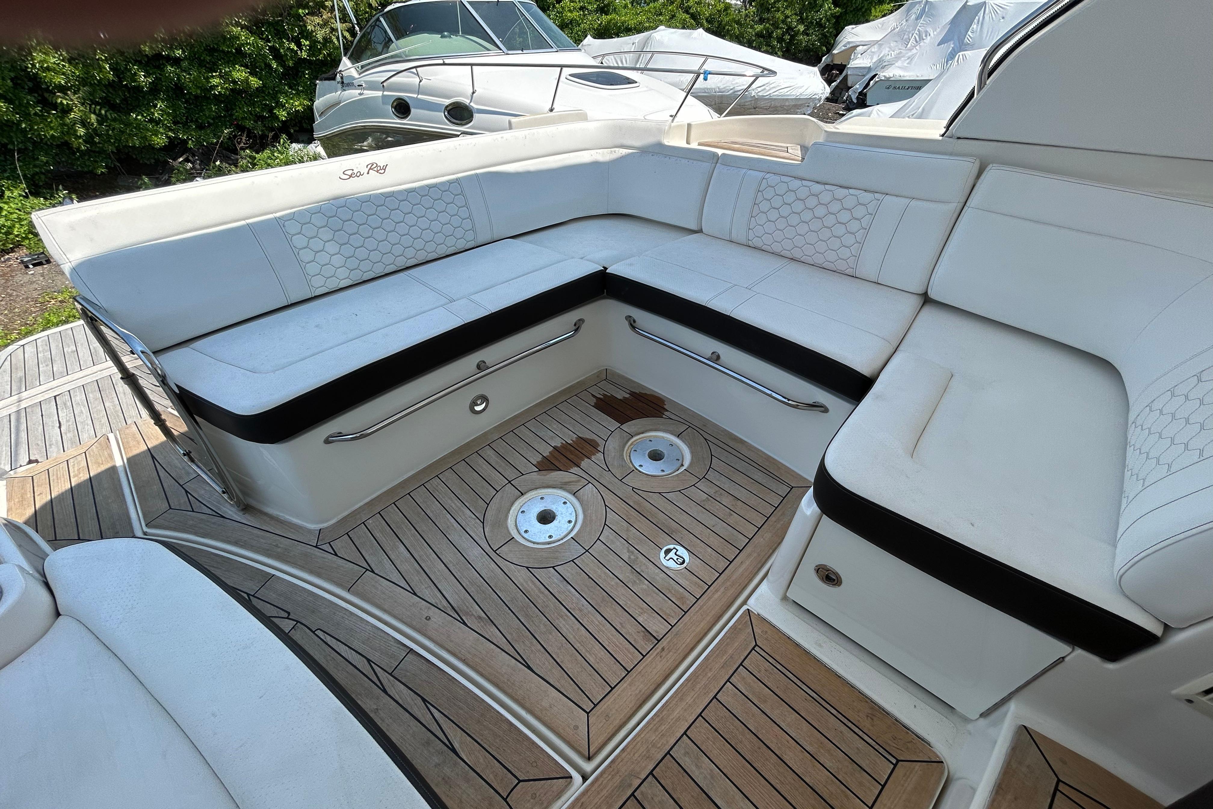 2019 Sea Ray Sundancer 350 boat interior with white seating and teak flooring.